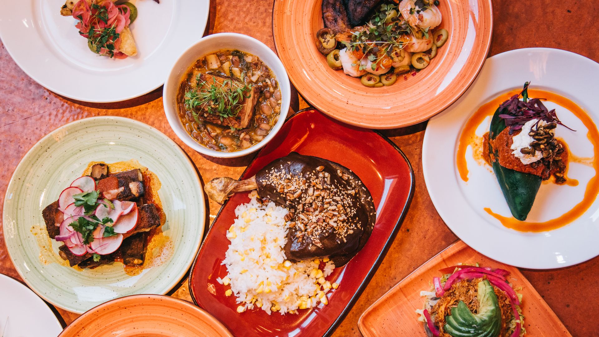 Plates of food from the restaurant Que Bueno Suerte in Denver