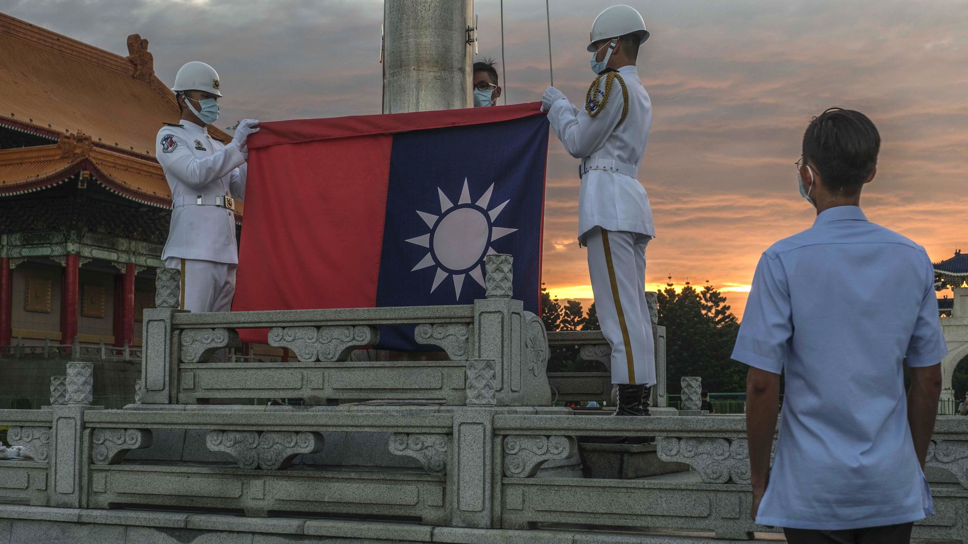 Soldiers lower the Taiwanese flag during a ceremony at the Chiang Kai-shek Memorial Hall in Taipei, Taiwan. on Thursday, Aug. 4.