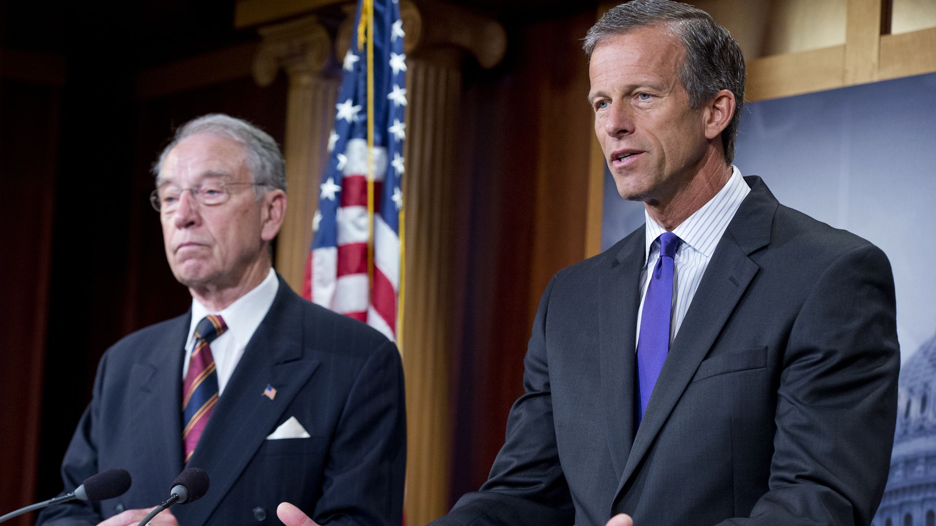 Senators Chuck Grassley and John Thune at the press conference, with an American flag behind them