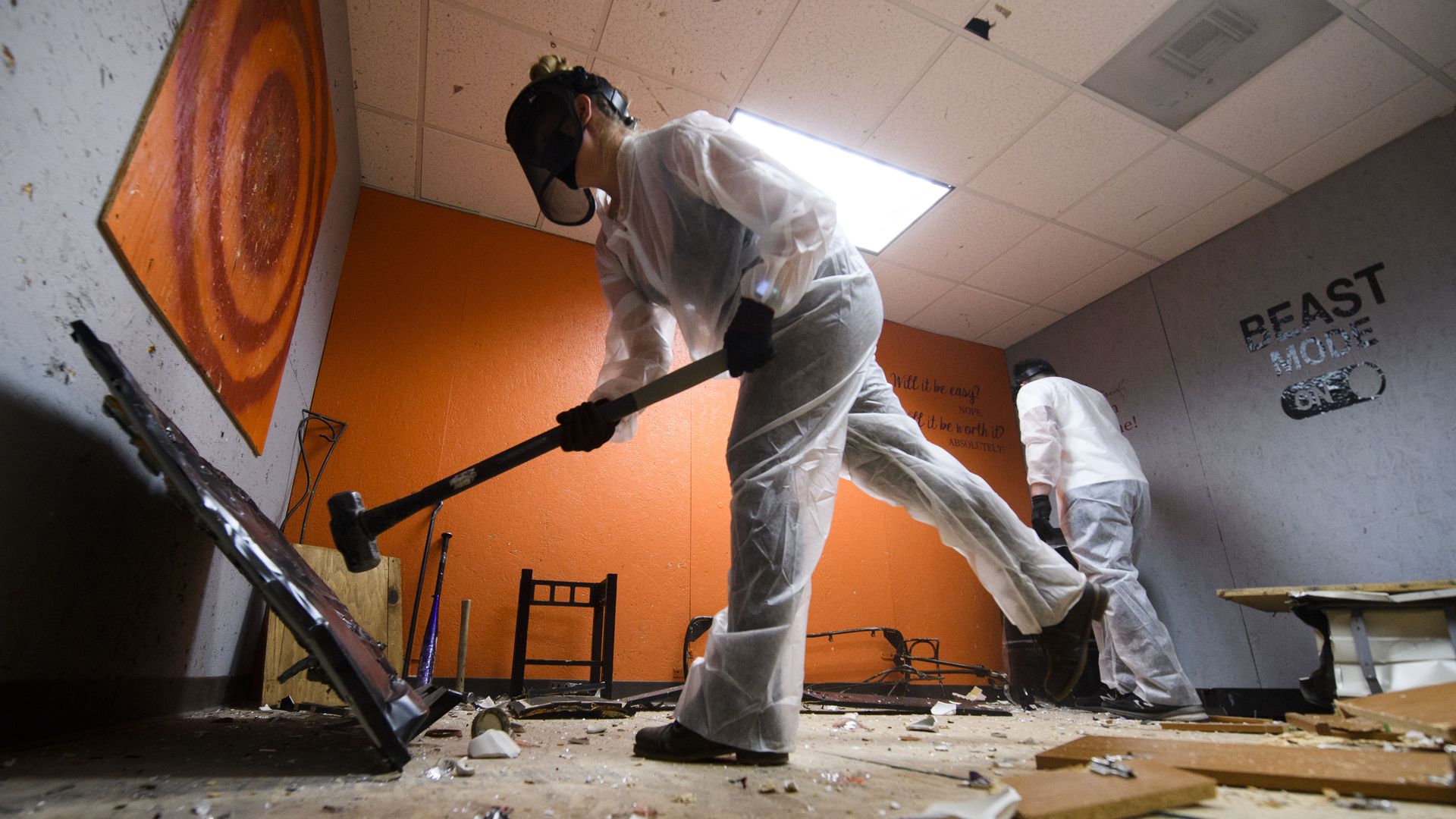 Erika Renau uses sledgehammer during a therapy session in a rage room at Smash RX on February 26, 2021 in Westlake Village, California. (Photo by PATRICK T. FALLON/AFP via Getty Images)  