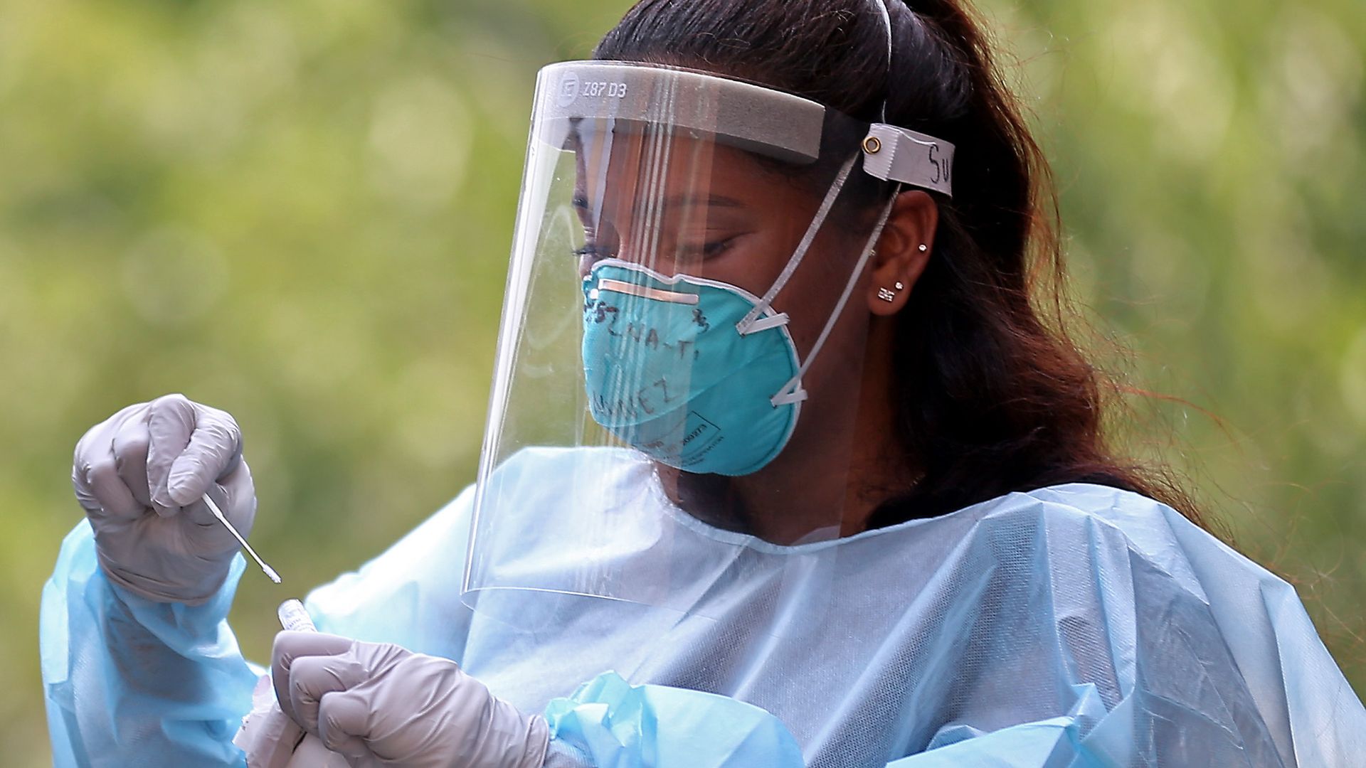A medical worker handling a coronavirus test in Charlestown, Massachusetts, on Aug. 11.