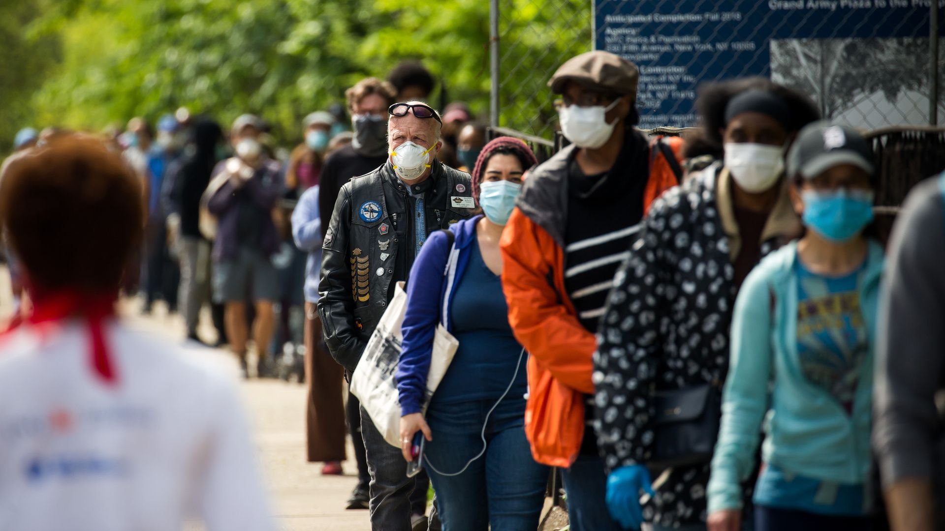 People wait in line for free masks in New York City.