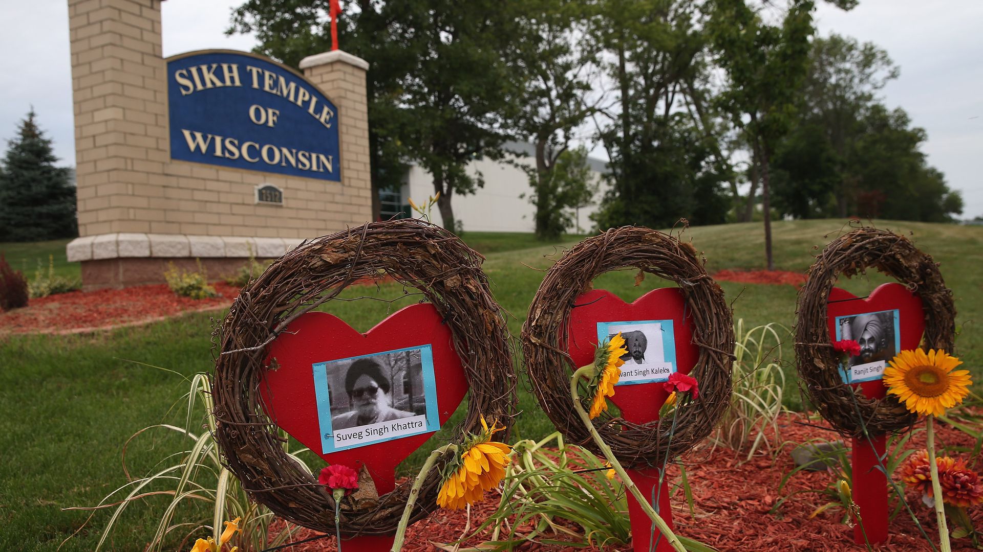 Photo of a sign that says "Sikh Temple of Wisconsin" and memorial sites showing pictures of victims 