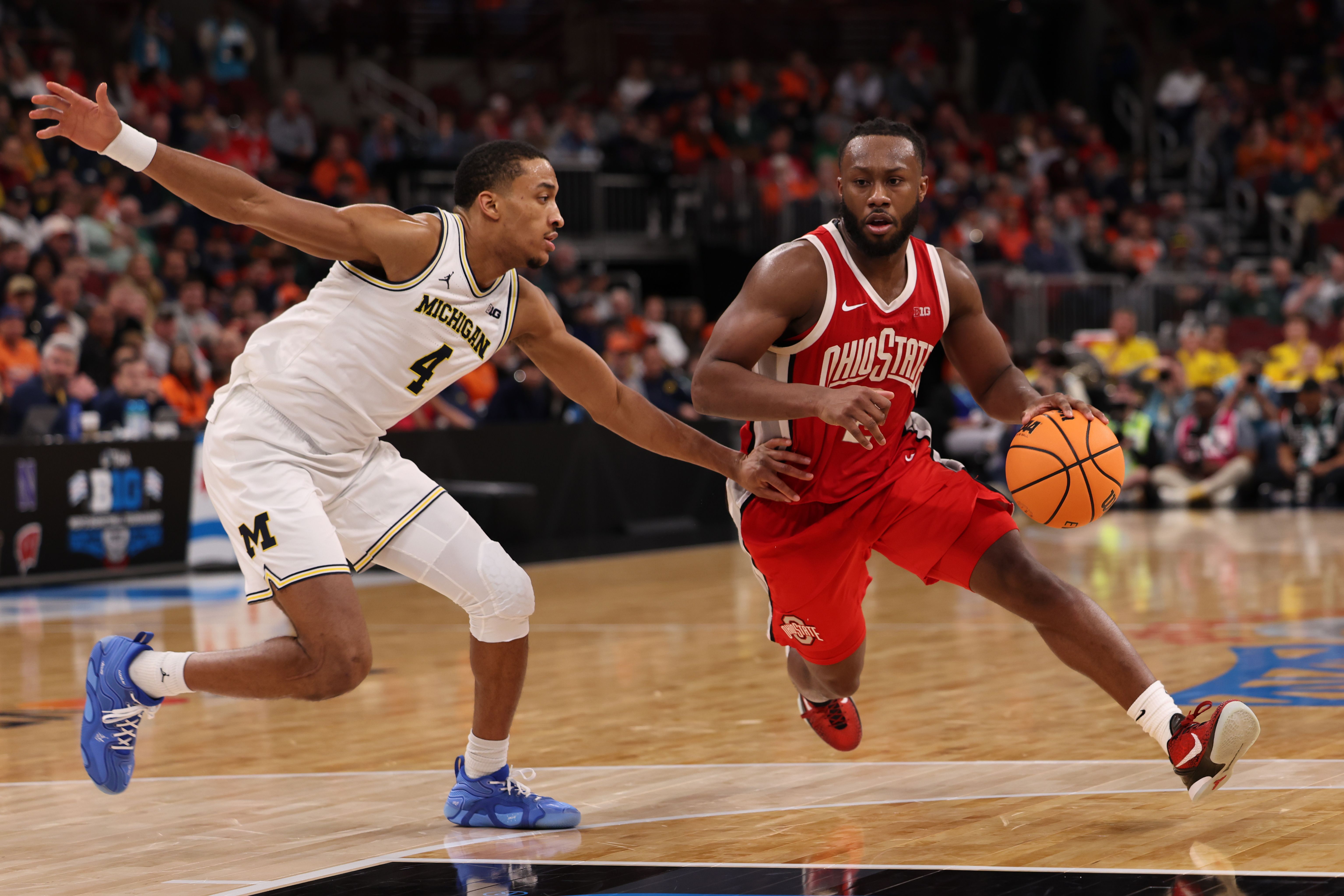 Bruce Thornton #2 of the Ohio State Buckeyes dribbles past Nimari Burnett #4 of the Michigan Wolverines