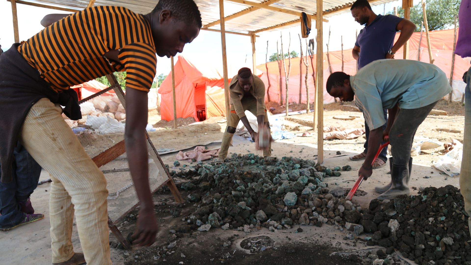 Miners are sort minerals on the road between Kolwezi and Lubumbashi, in the Congo, on February 15, 2018. 