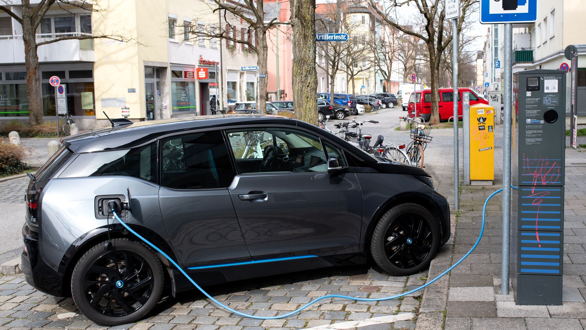 n electric car (BMW I3) is charged at a charging station.