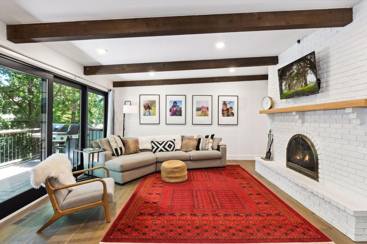 living room with fireplace and leading to deck