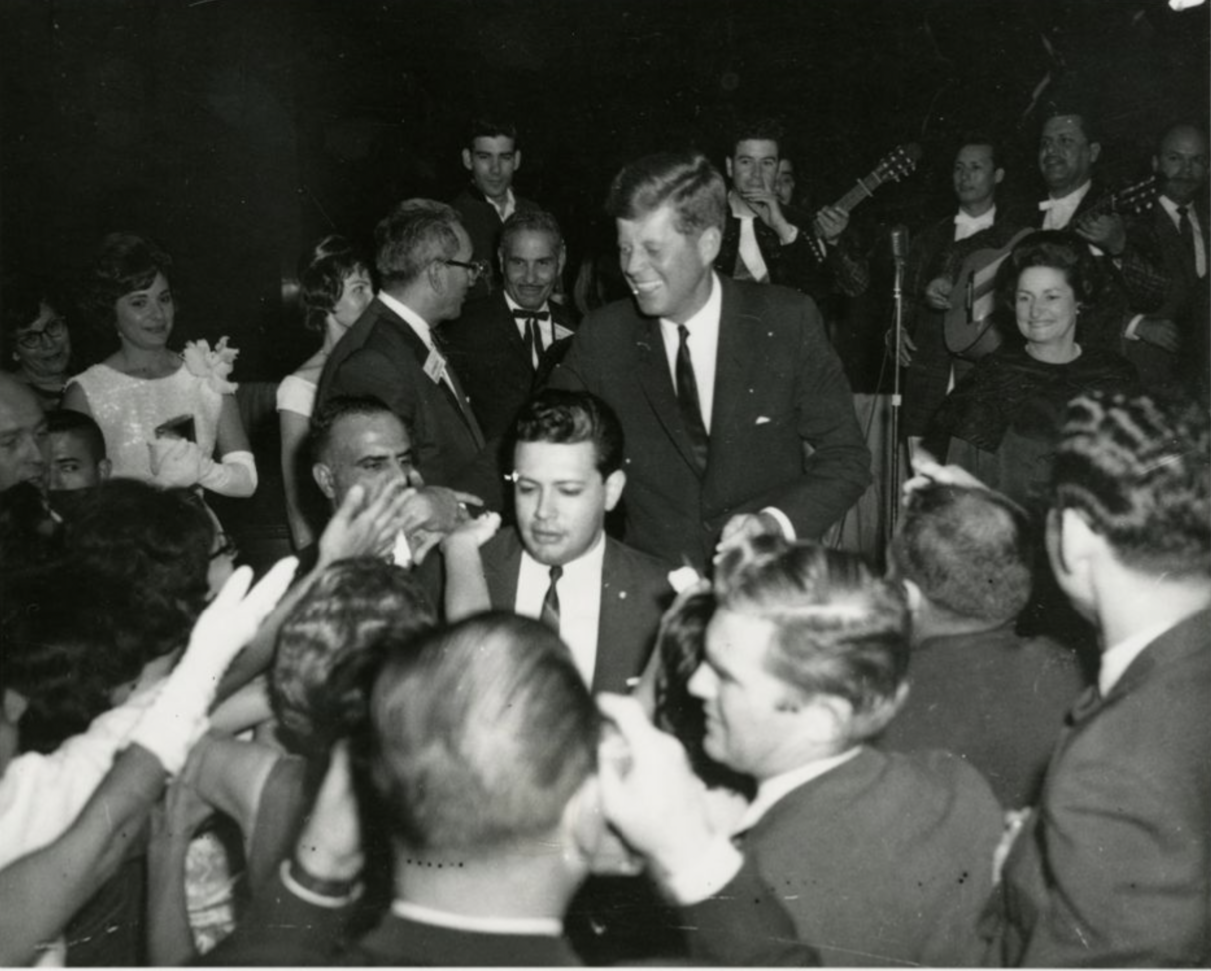 President Kennedy shakes hands with Mexican American activists at a LULAC gala at the Rice Hotel.