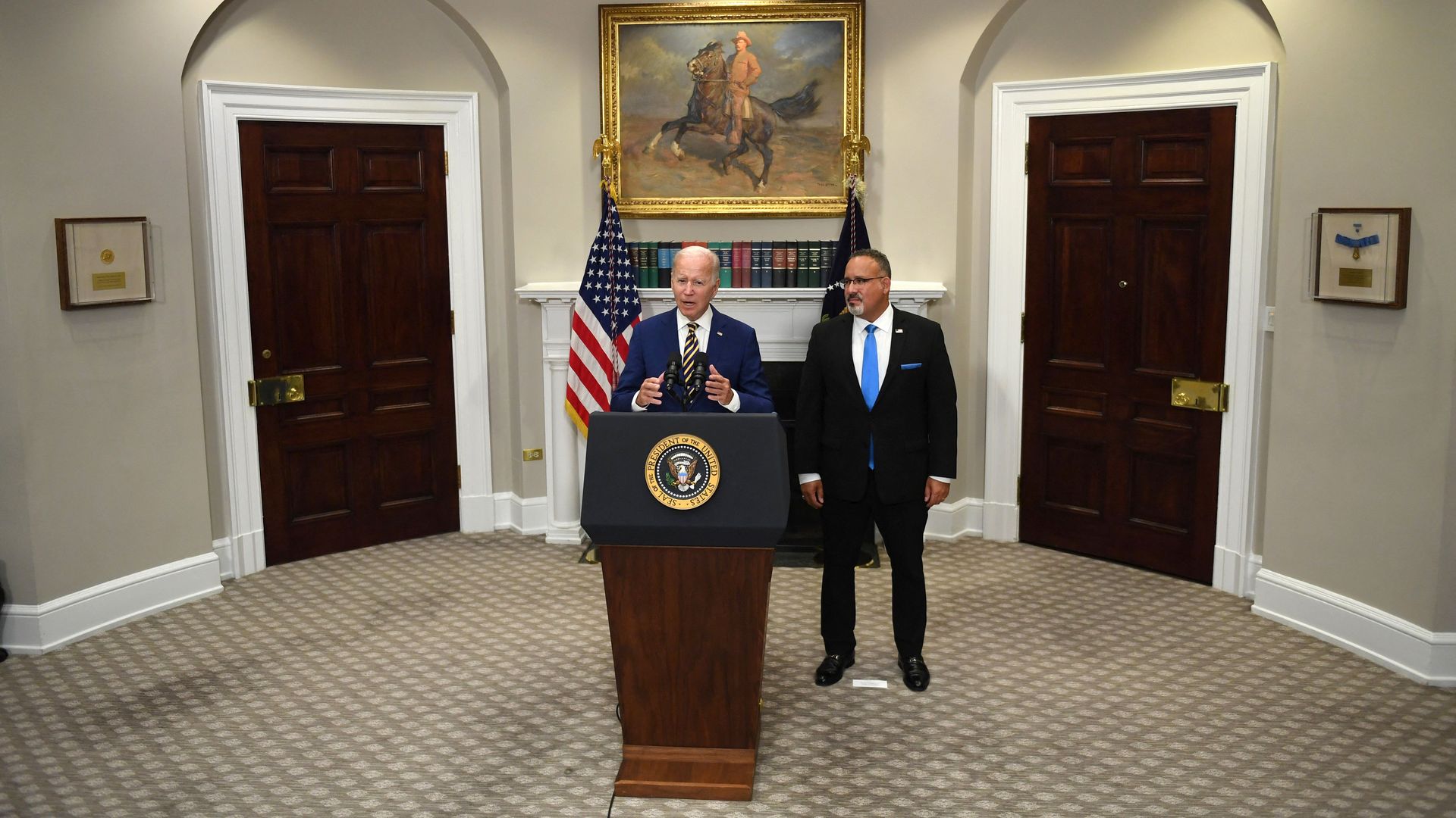 President Joe Biden announces student loan relief with Education Secretary Miguel Cardona (R) on August 24, 2022 in the Roosevelt Room of the White House in Washington, DC. 