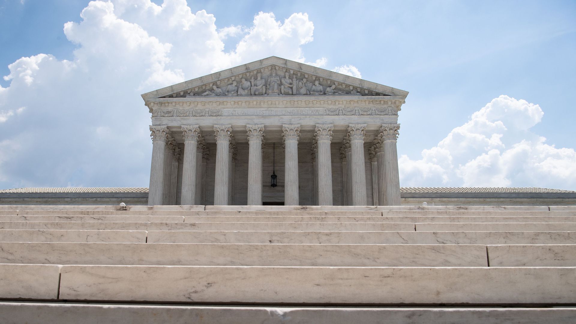 The steps of the Supreme Court in the foreground with the building in the background. 