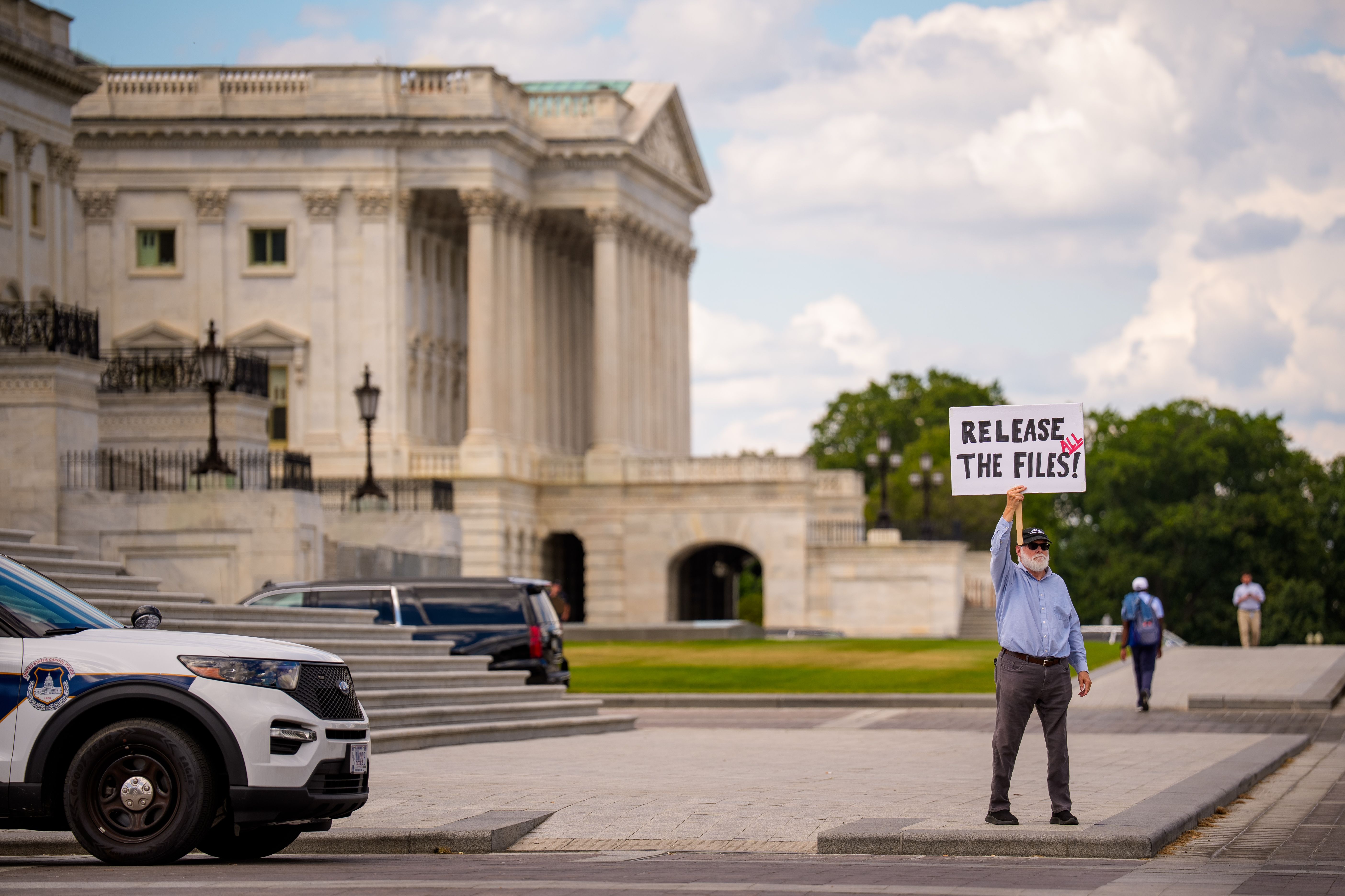 A protester holds up a sign outside the Capitol. 