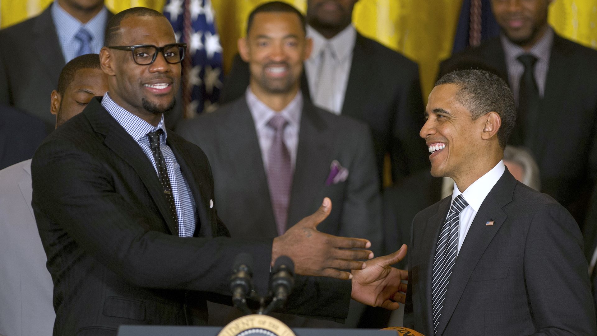 President Barack Obama (R) poses with LeBron James as he welcomes the NBA Champion Miami Heat to the White House to honor the team in 2013