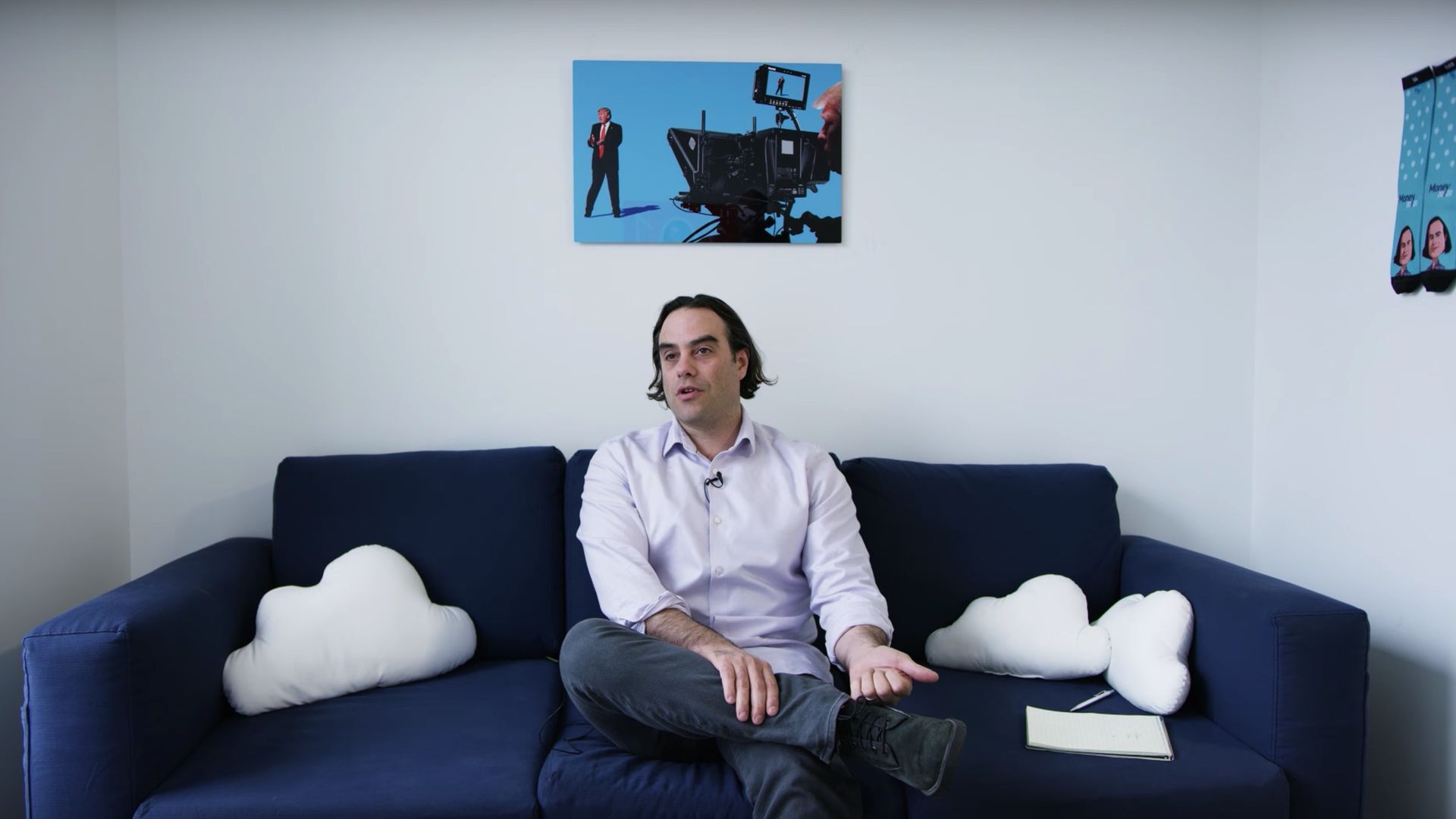Screenshot of Dan Primack talking in a video as he sits on a couch