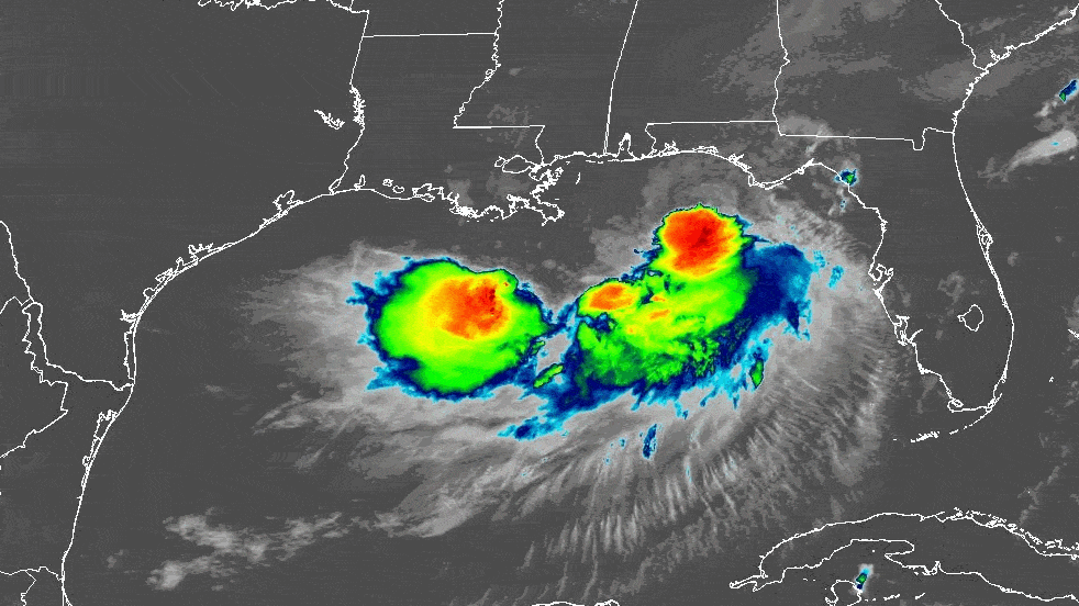Image is a satellite view of Tropical Storm Bertha in the Gulf, with bands of red, yellow, green and blue.