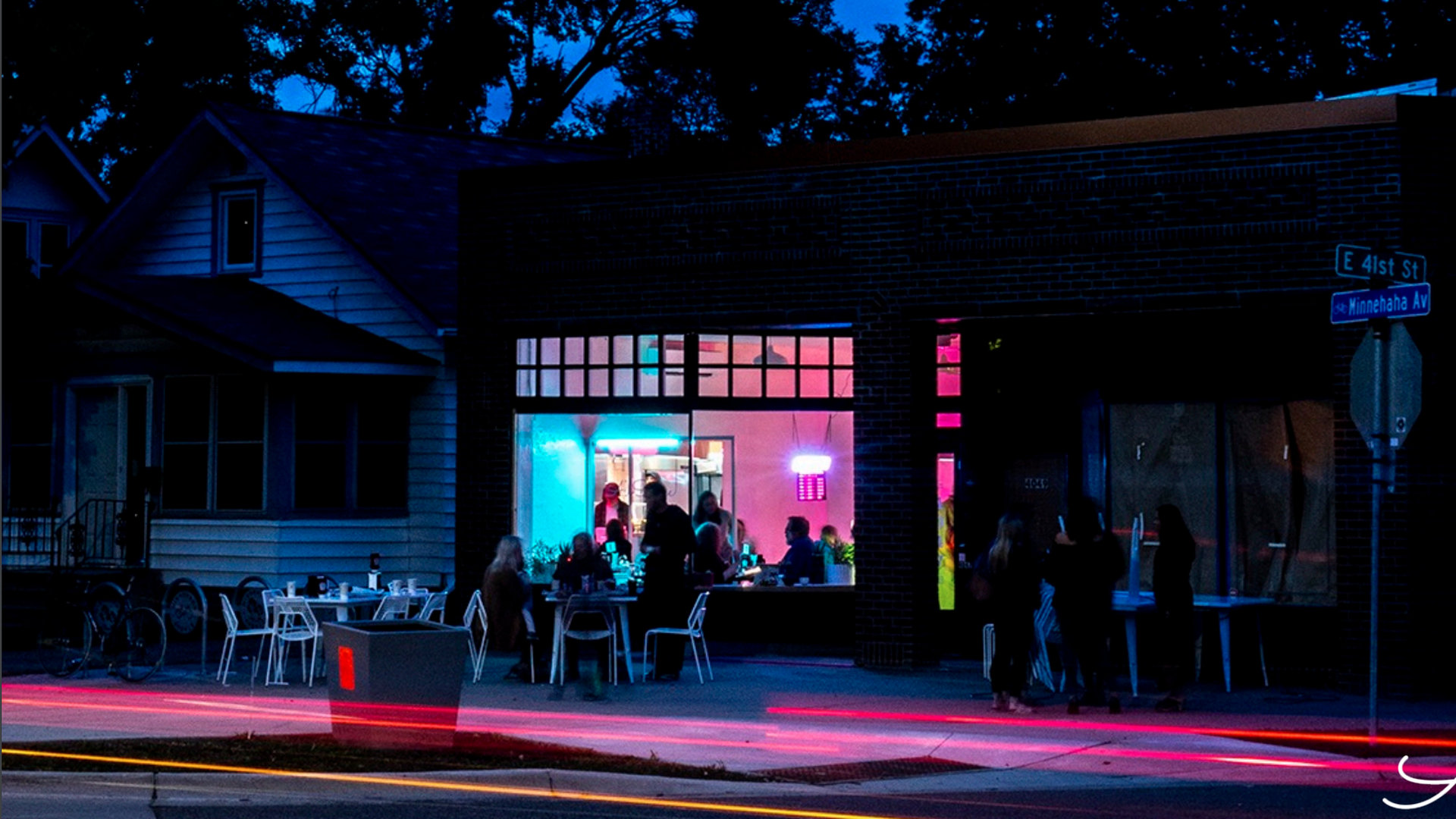 The exterior of All Square restaurant as seen at night.