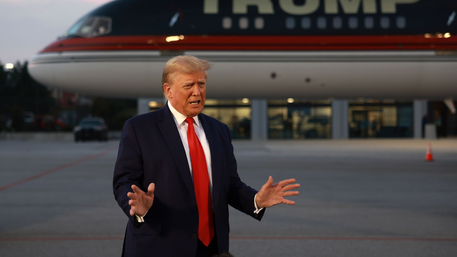 Former U.S. President Donald Trump speaks to the media at Atlanta Hartsfield-Jackson International Airport after surrendering at the Fulton County jail on August 24, 2023 in Atlanta, Georgia. 