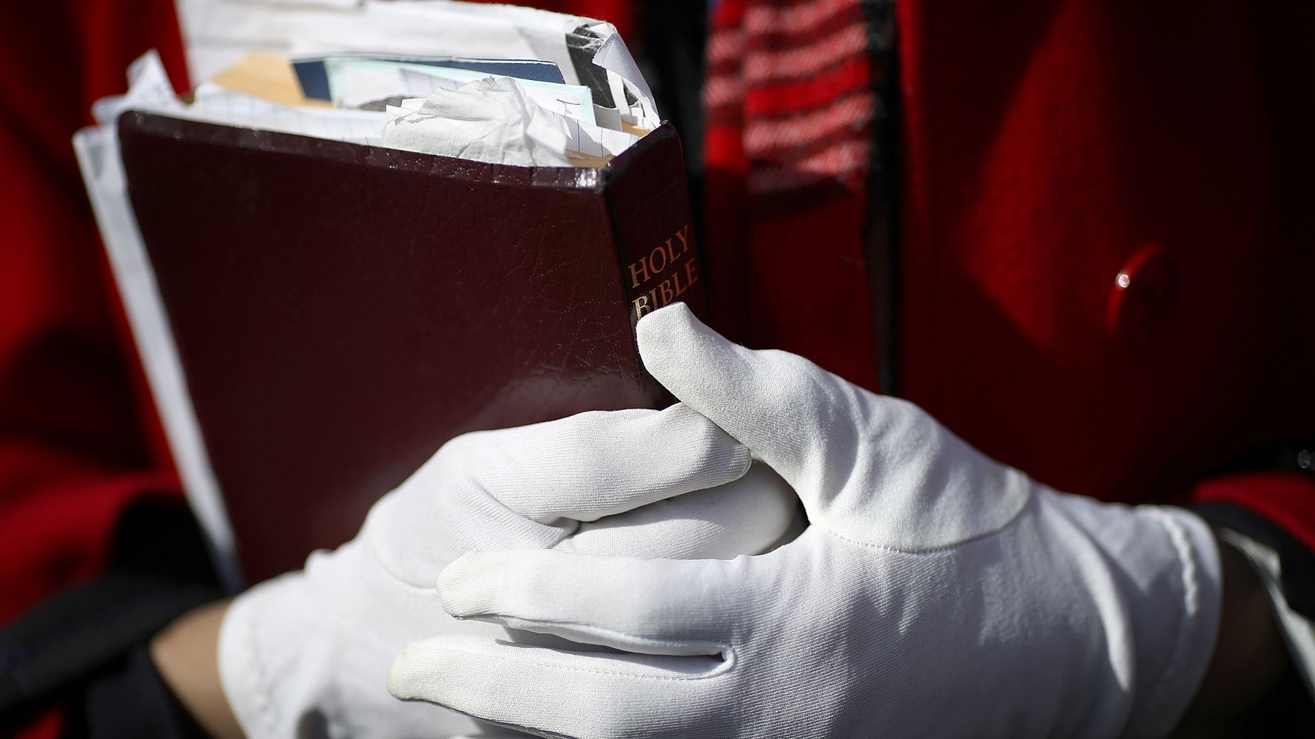 Evangelist Mary Clement holds her Bible in her hands while waiting.