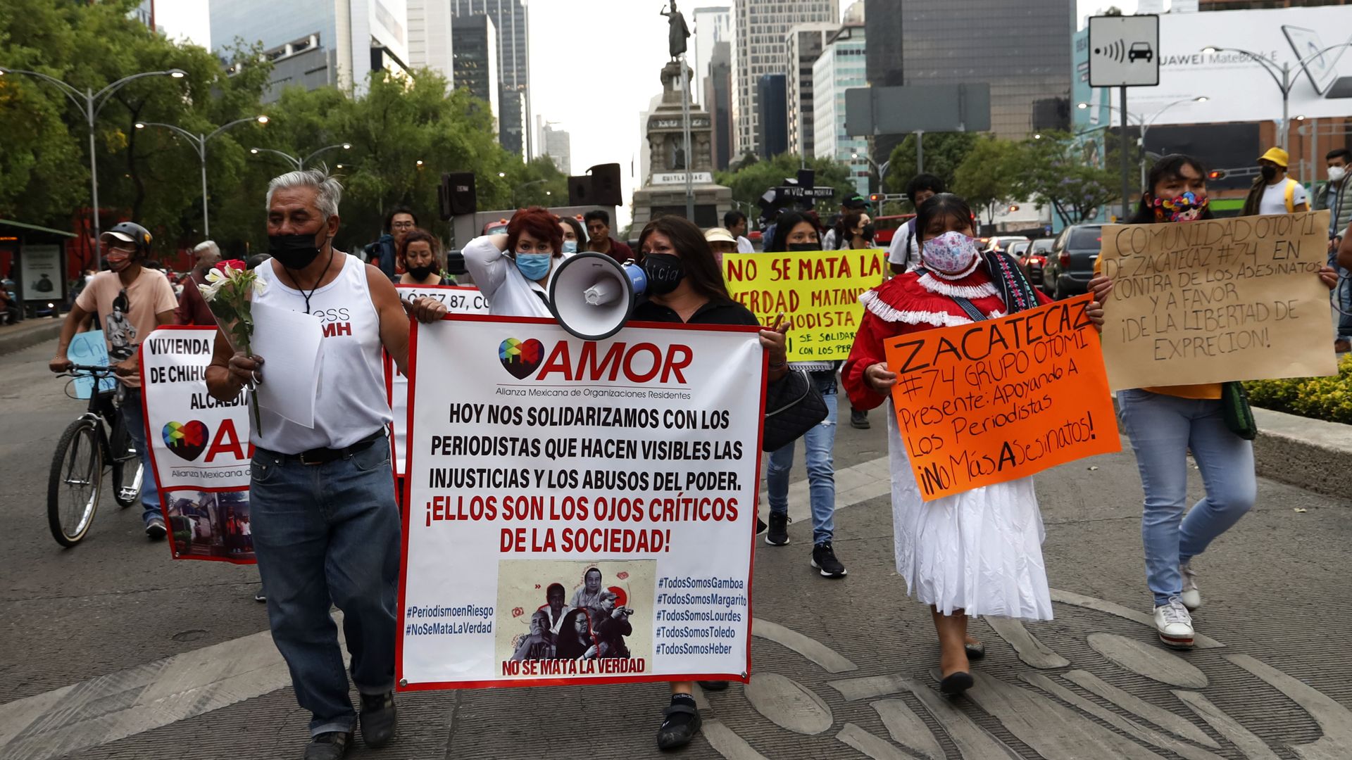 Protesters carrying signs and banners march for journalists' safety in Mexico City 