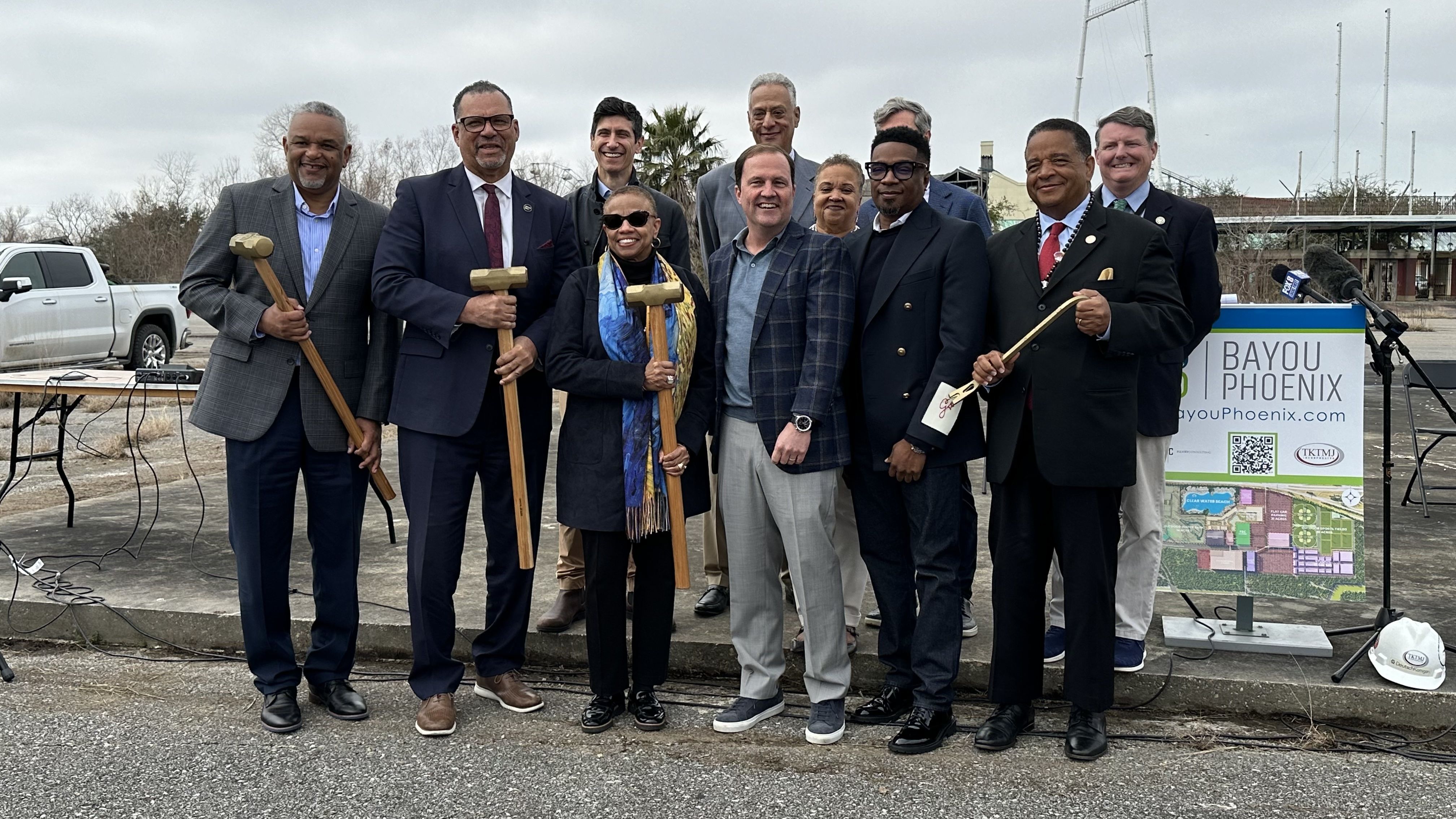 Photo shows leaders with gold sledgehammers.