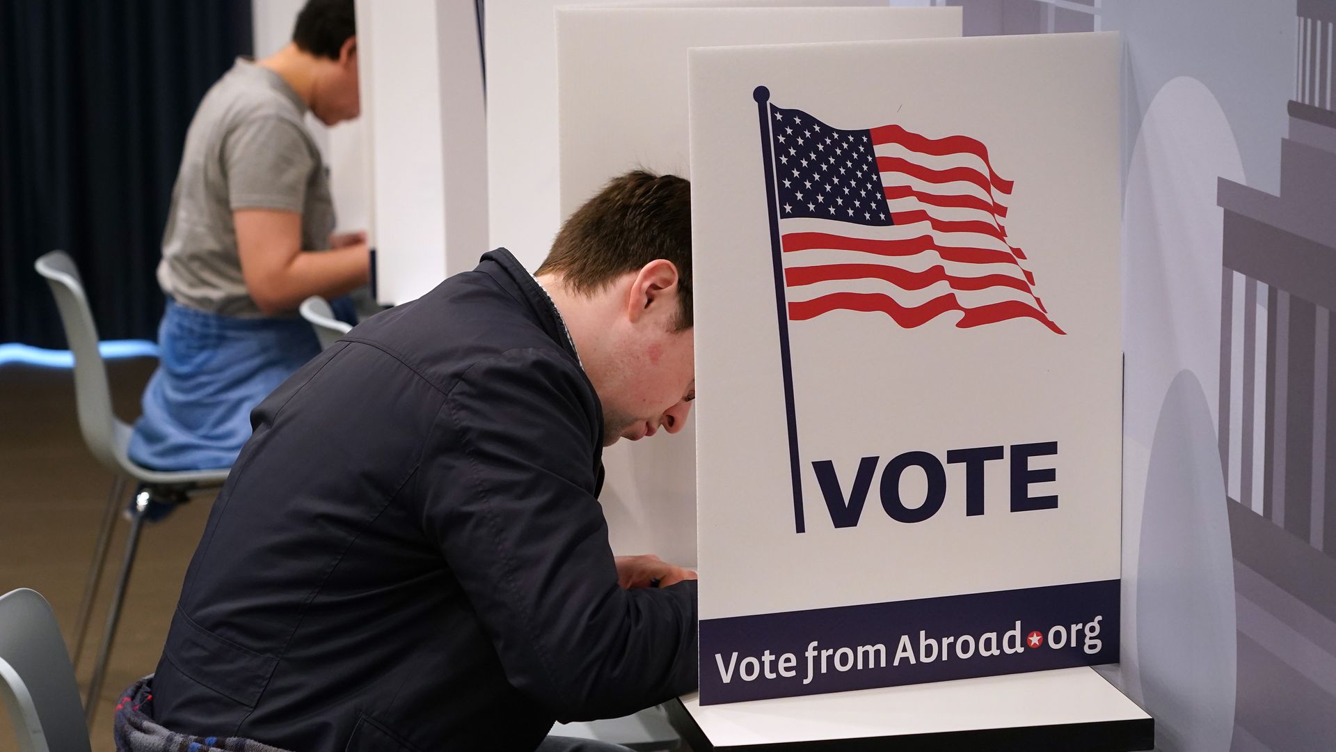 A person in a voting booth.