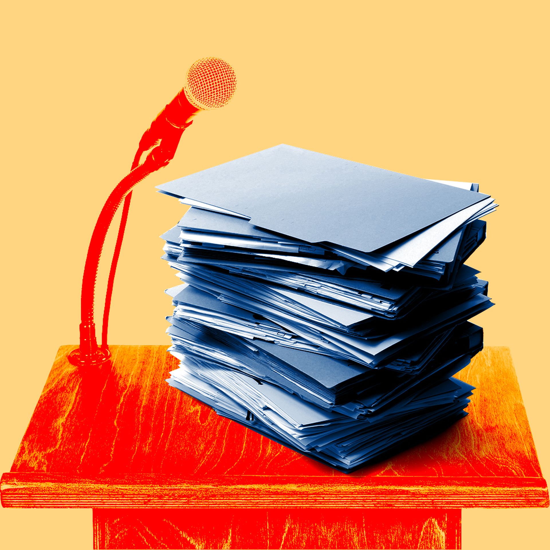 stack of file folders on a lectern with a microphone