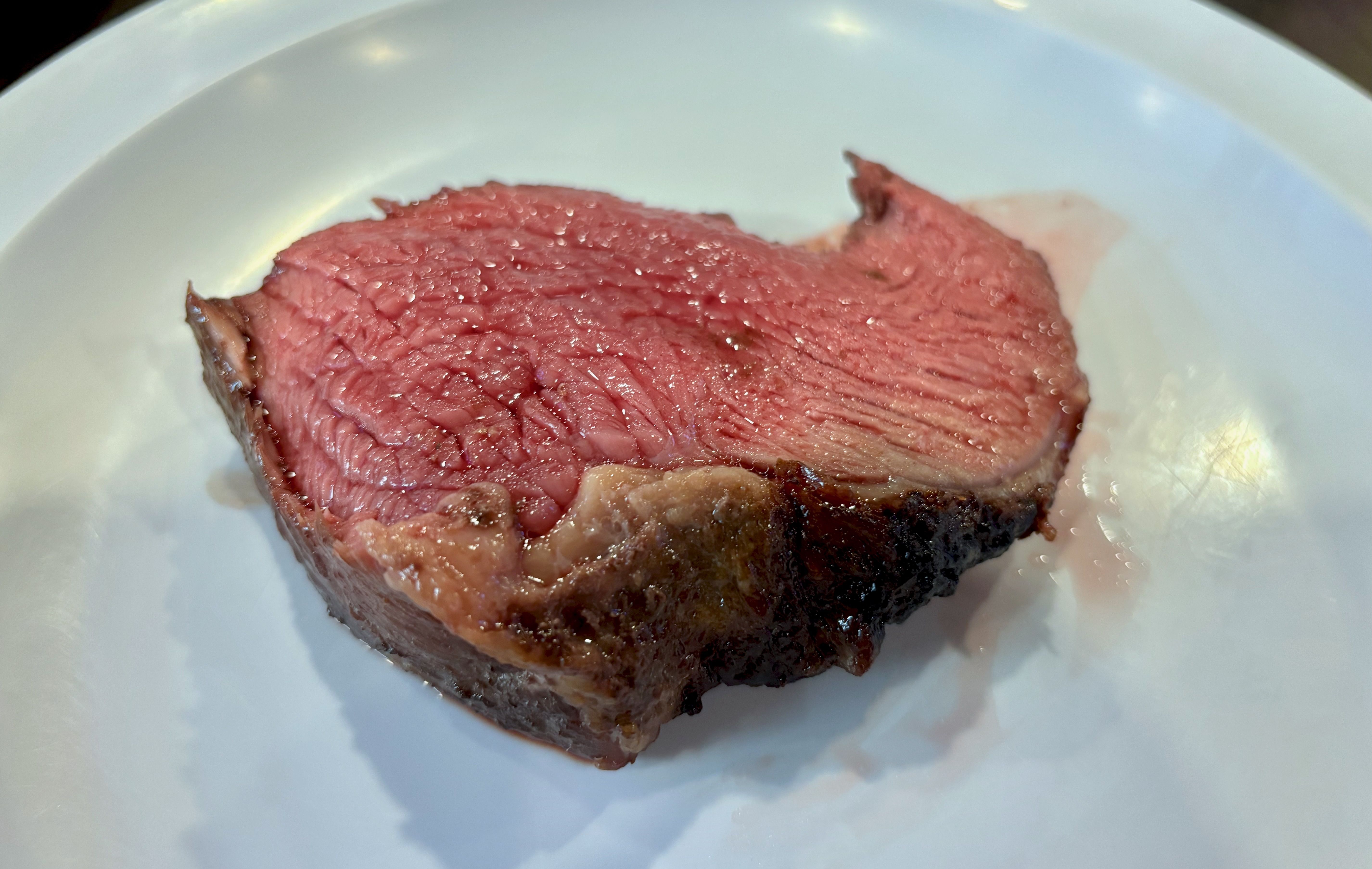 A close-up of a cut of top sirloin, known as picanha