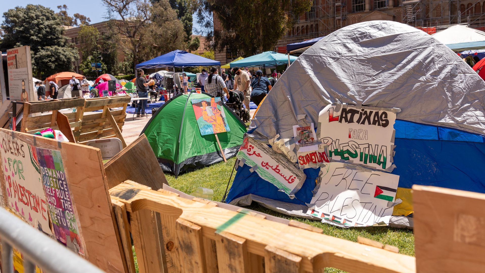 Students rest at a Gaza solidarity camp at UCLA in Los Angeles on April 27, 2024. 