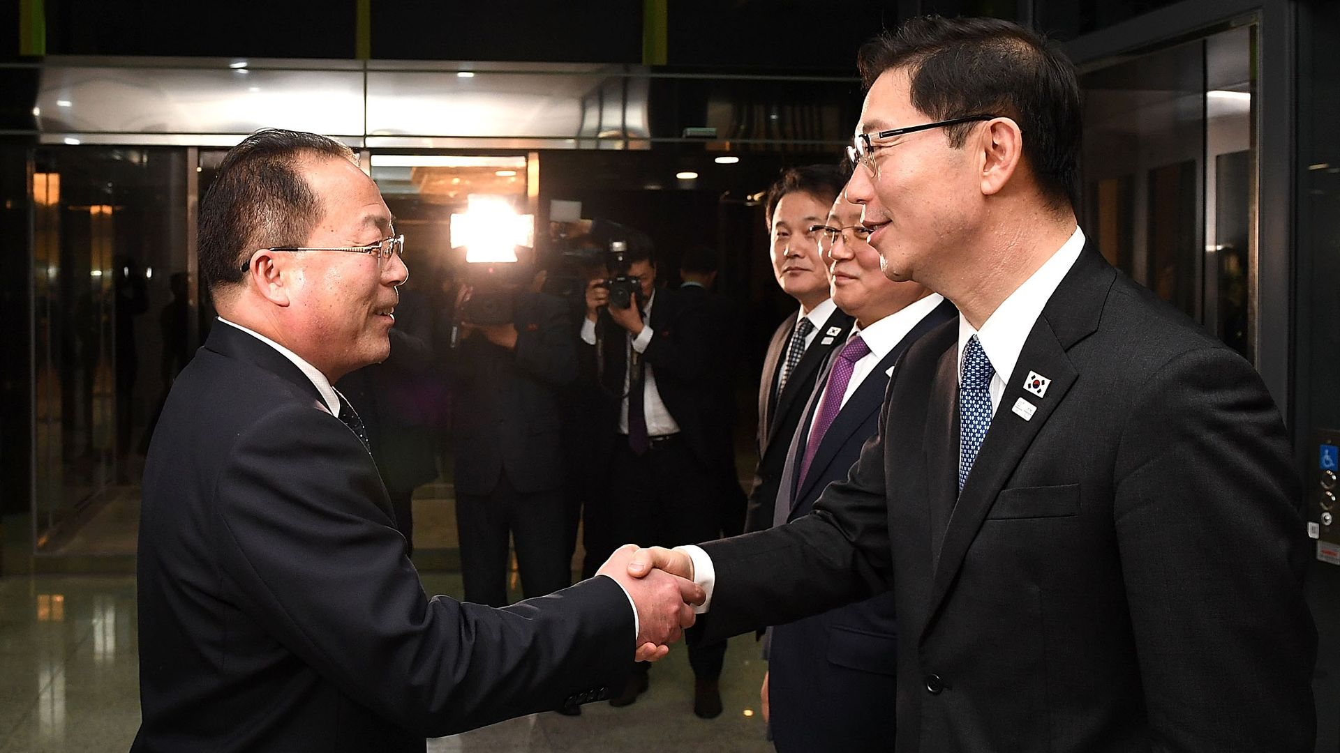 North and South Korean delegation leaders shake hands
