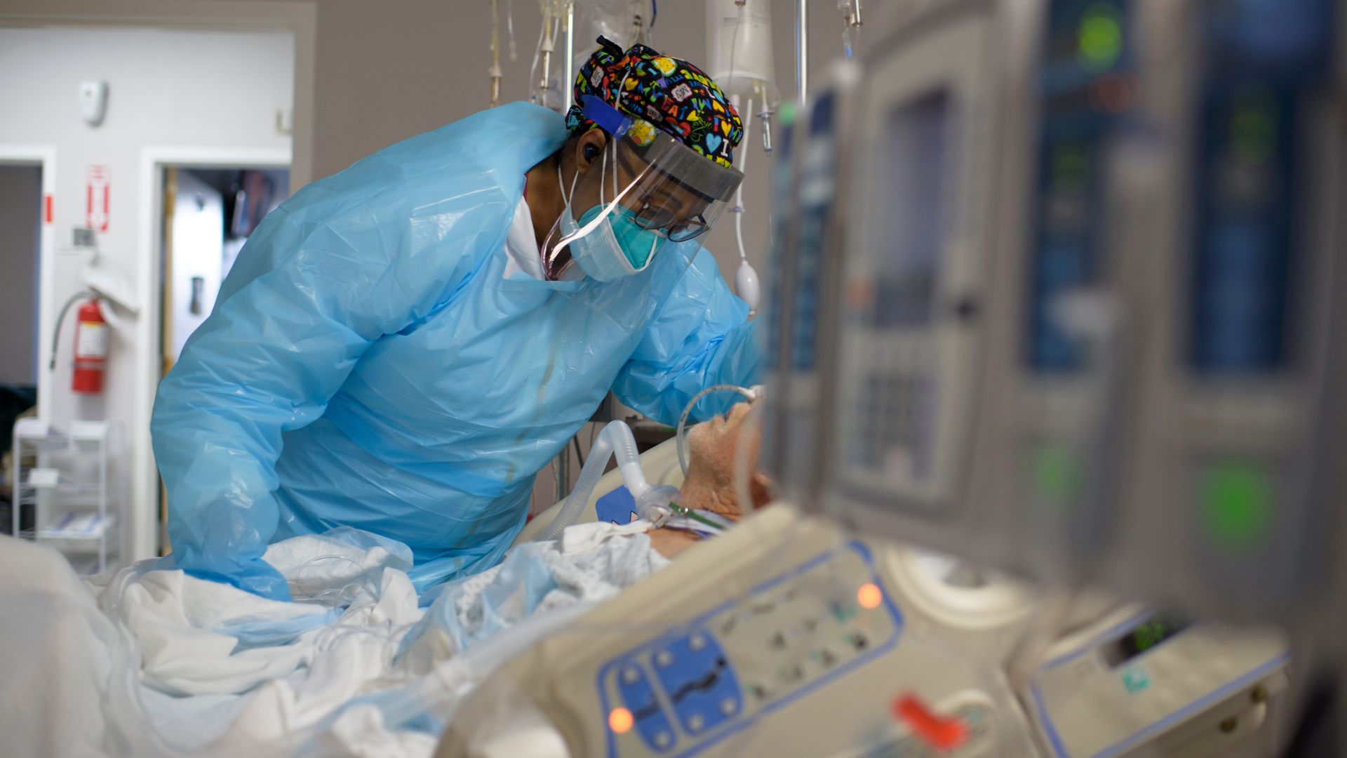 Healthcare worker Demetra Ransom comforts a patient in the Covid-19 ward at United Memorial Medical Center in Houston, Texas on December 4