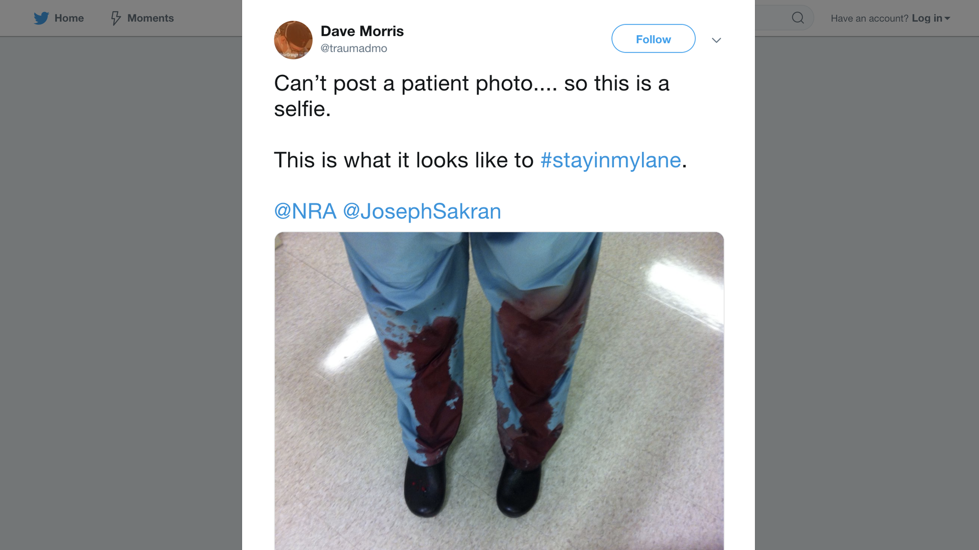 A photo of a doctor's legs with blood from a patient on them
