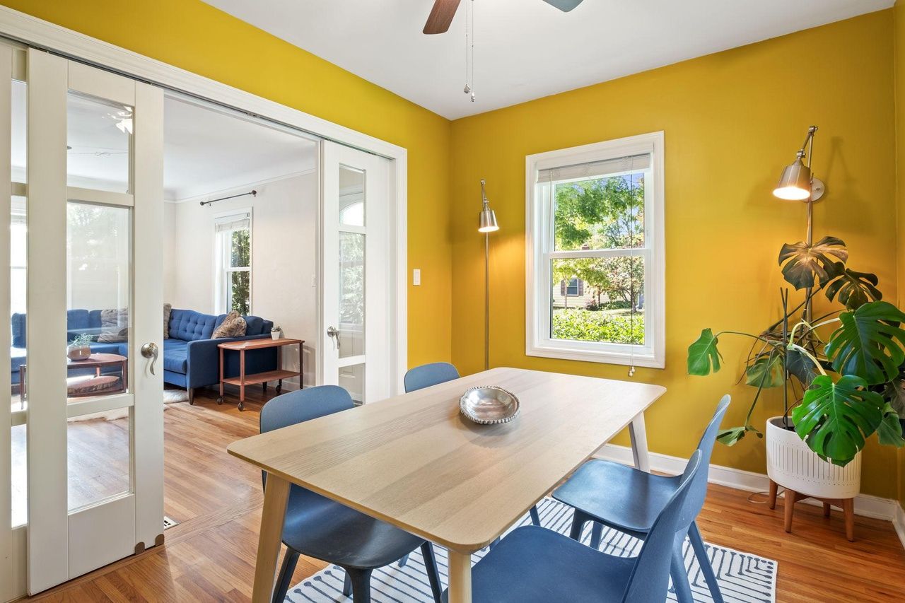bright yellow dining room with french doors