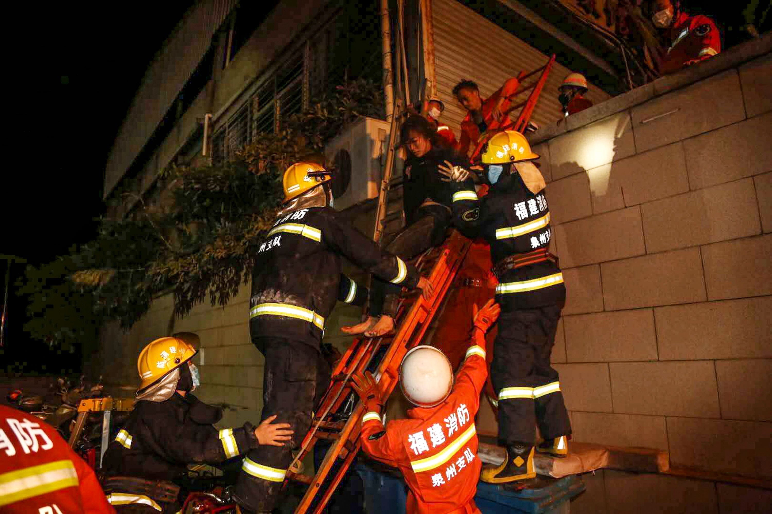 In this image, people are helped down a ladder