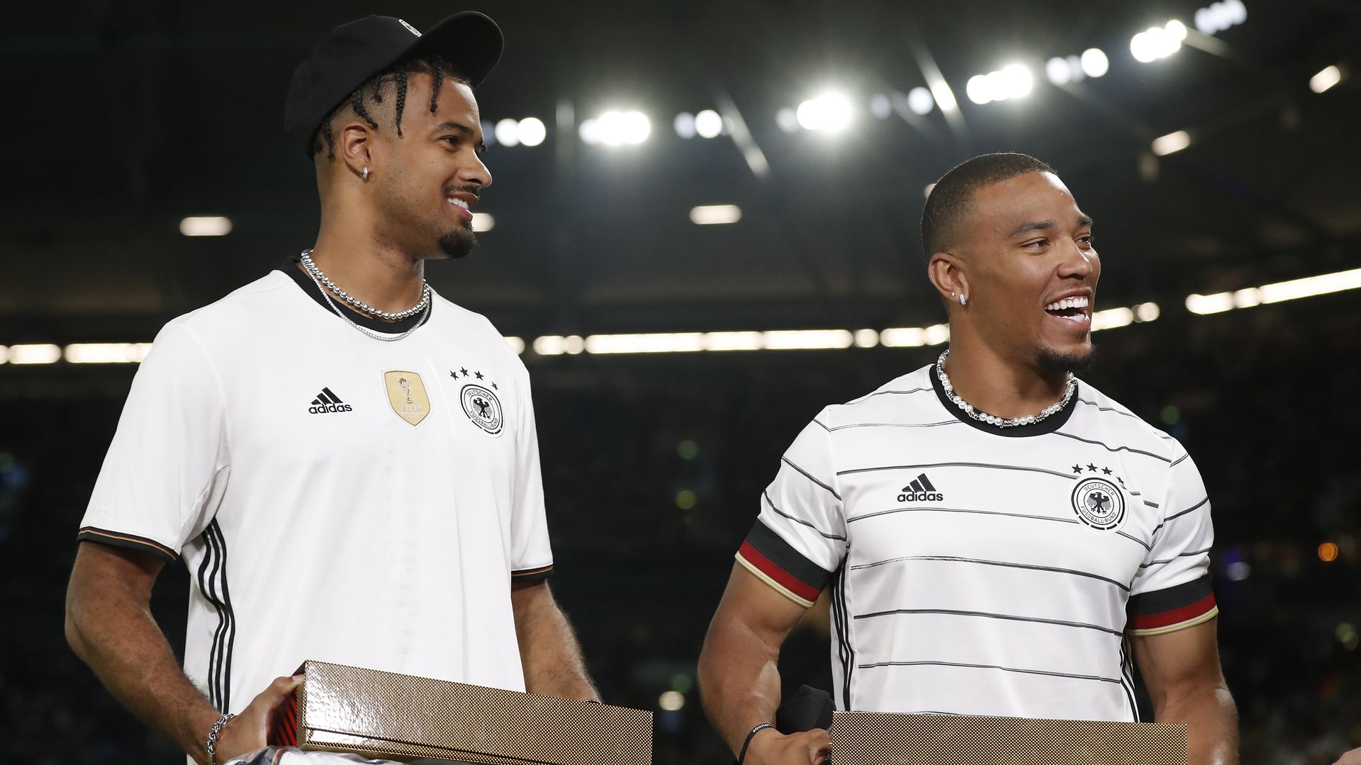 Lions receiver Amon-Ra St. Brown, right, with his brother, Equanimeous St. Brown, at an international soccer friendly in Germany in 2023.