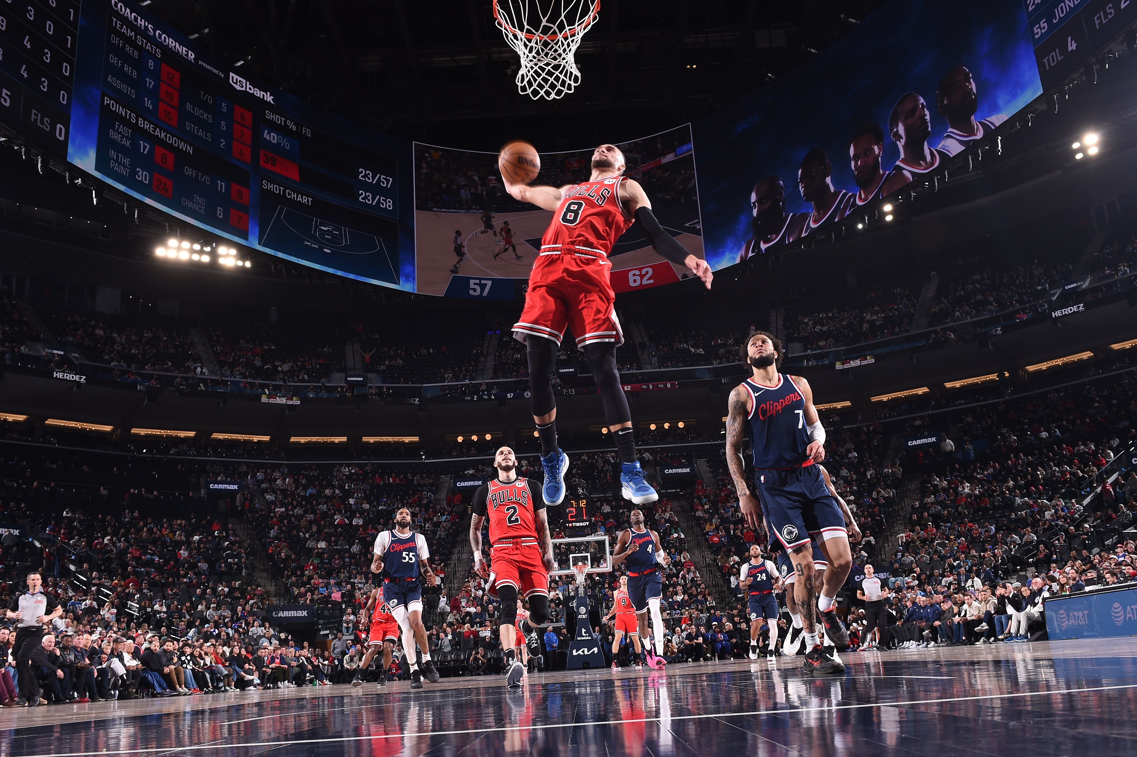 Photo of a basketball player jumping into the air during a game 