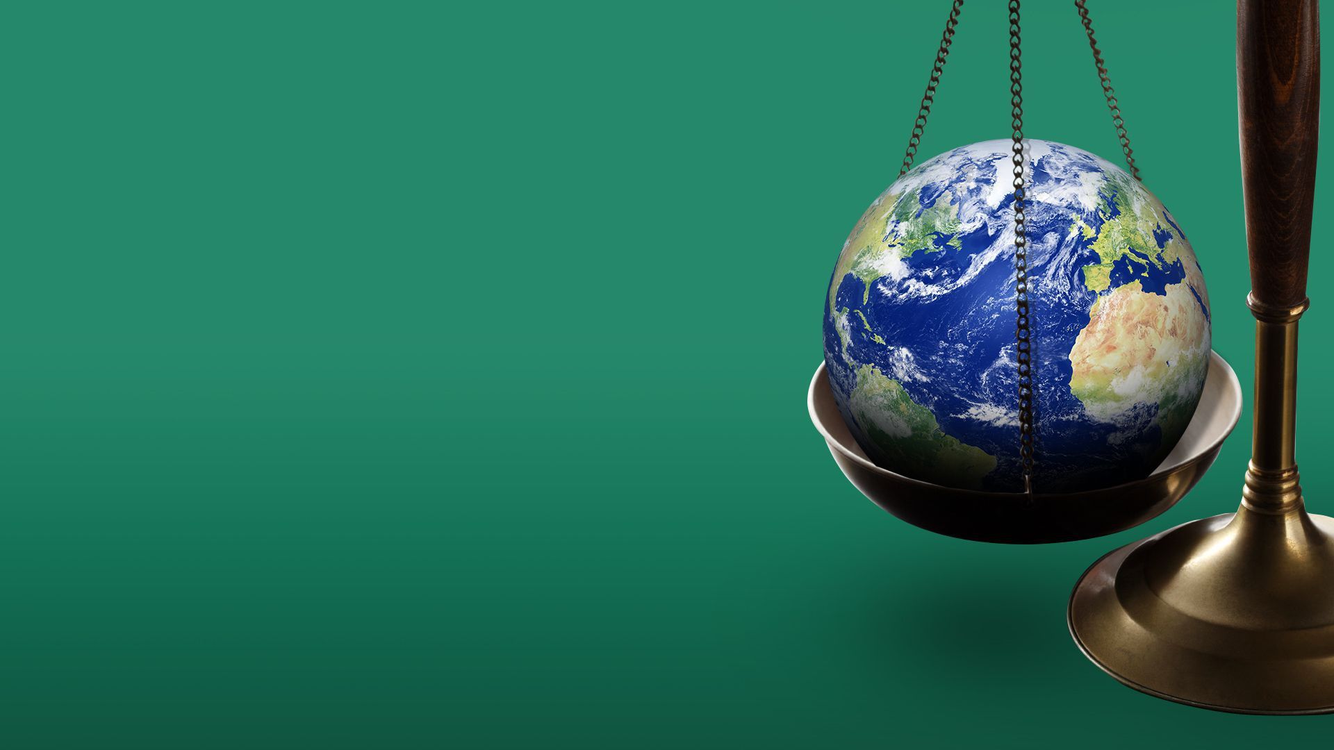 Illustration of the Earth inside of a balance scale.