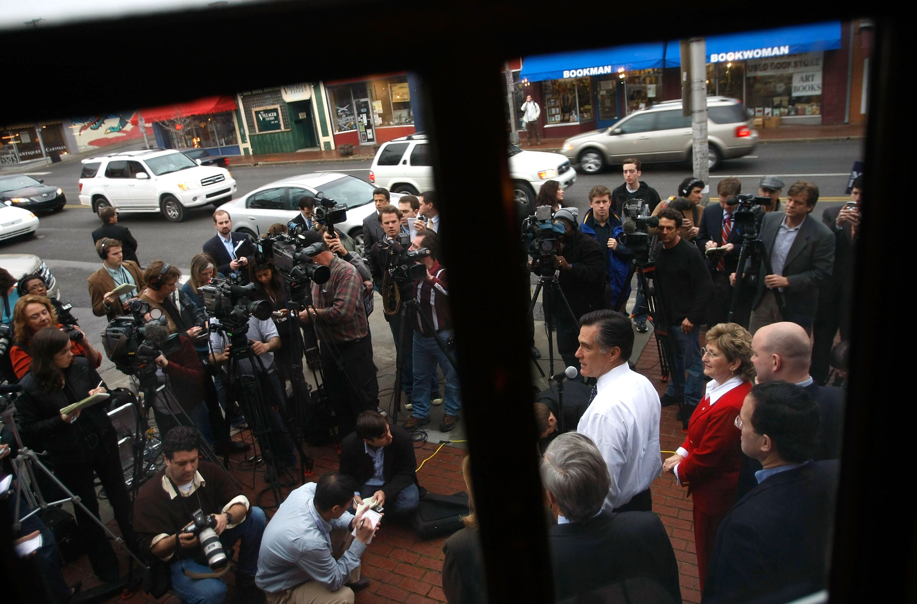 Mitt Romney speaks to a scrum of reporters.