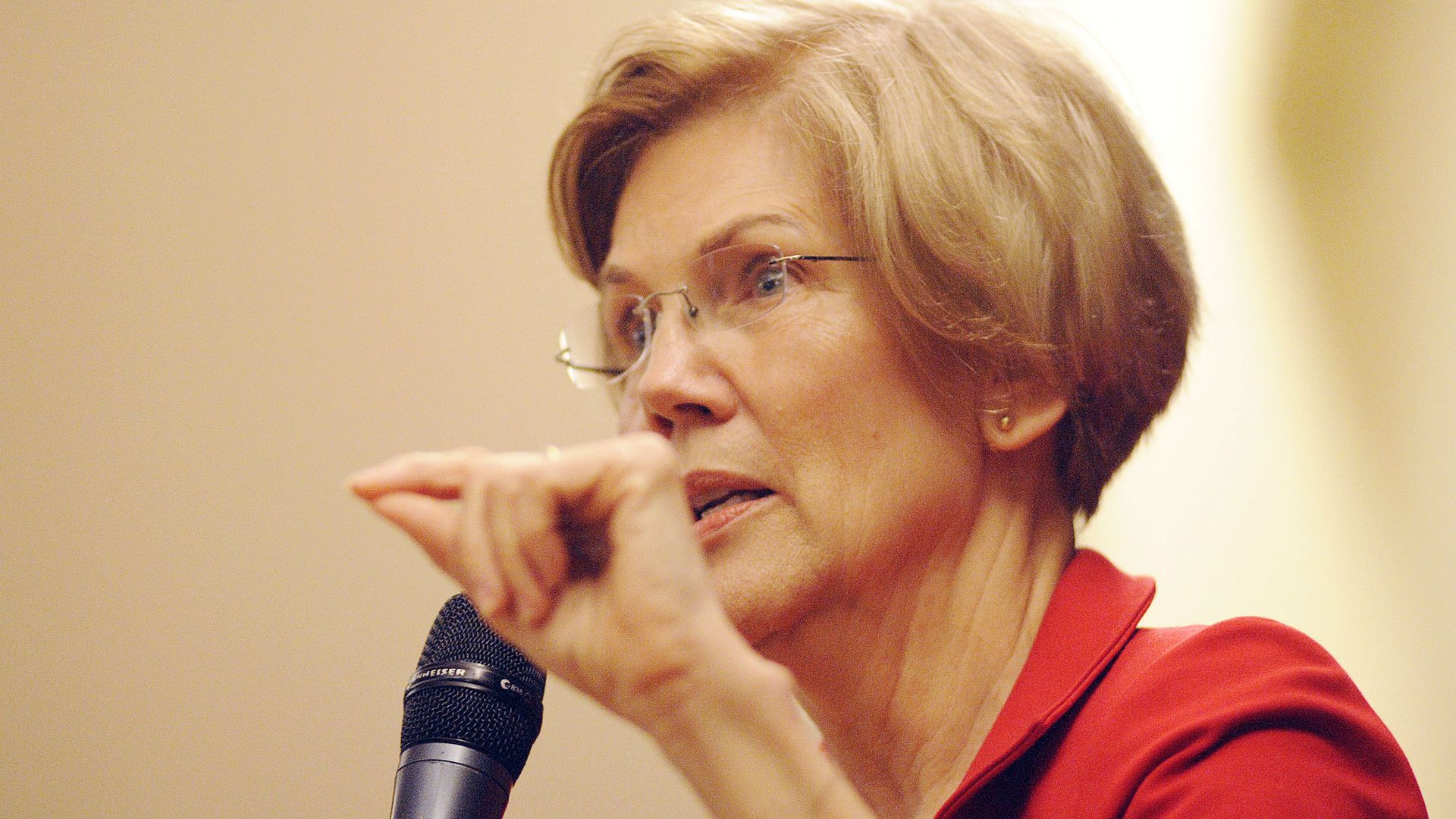 Wlizabeth Warren close up with a microphone. 