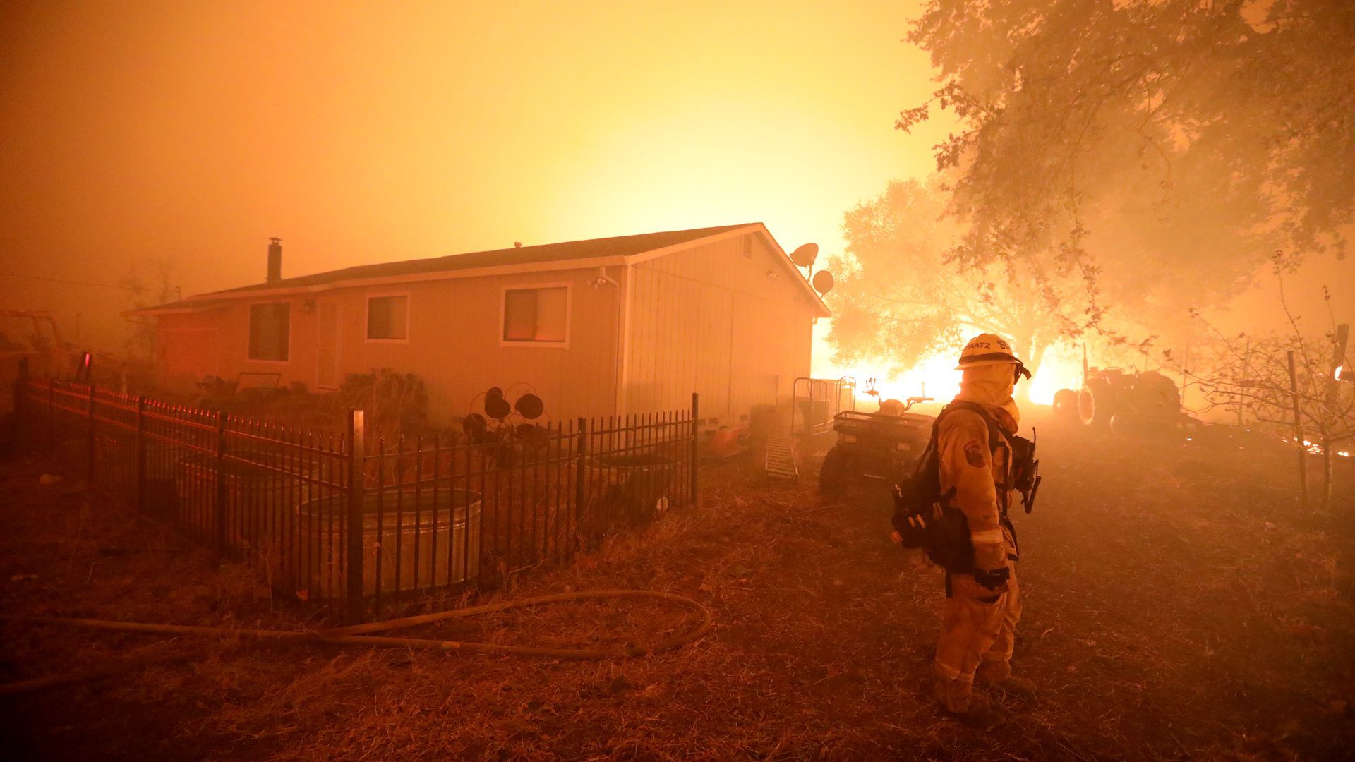 A Cal Fire firefighter watches over a structure threatened by the Kincade Fire on Oct. 27. 