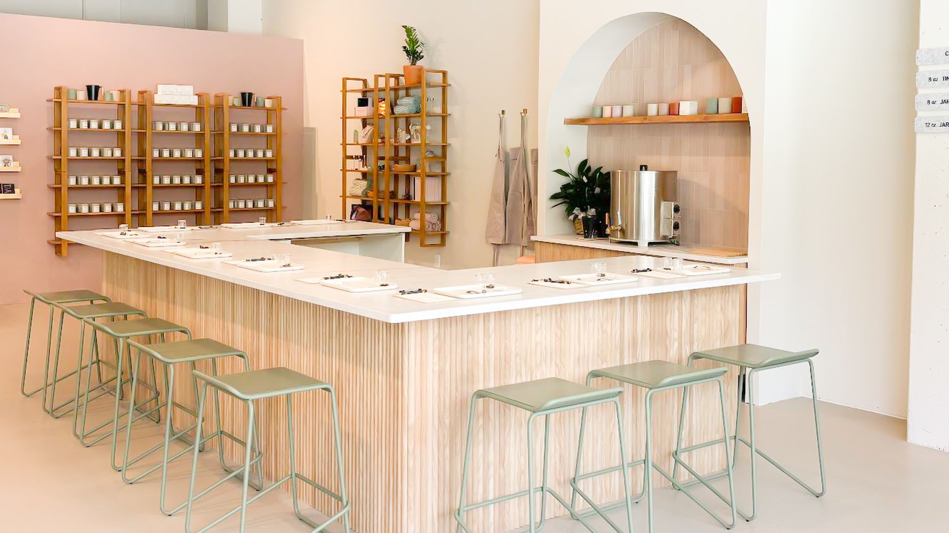 An image of a U-shaped bar for making candles, with bar stool seating.