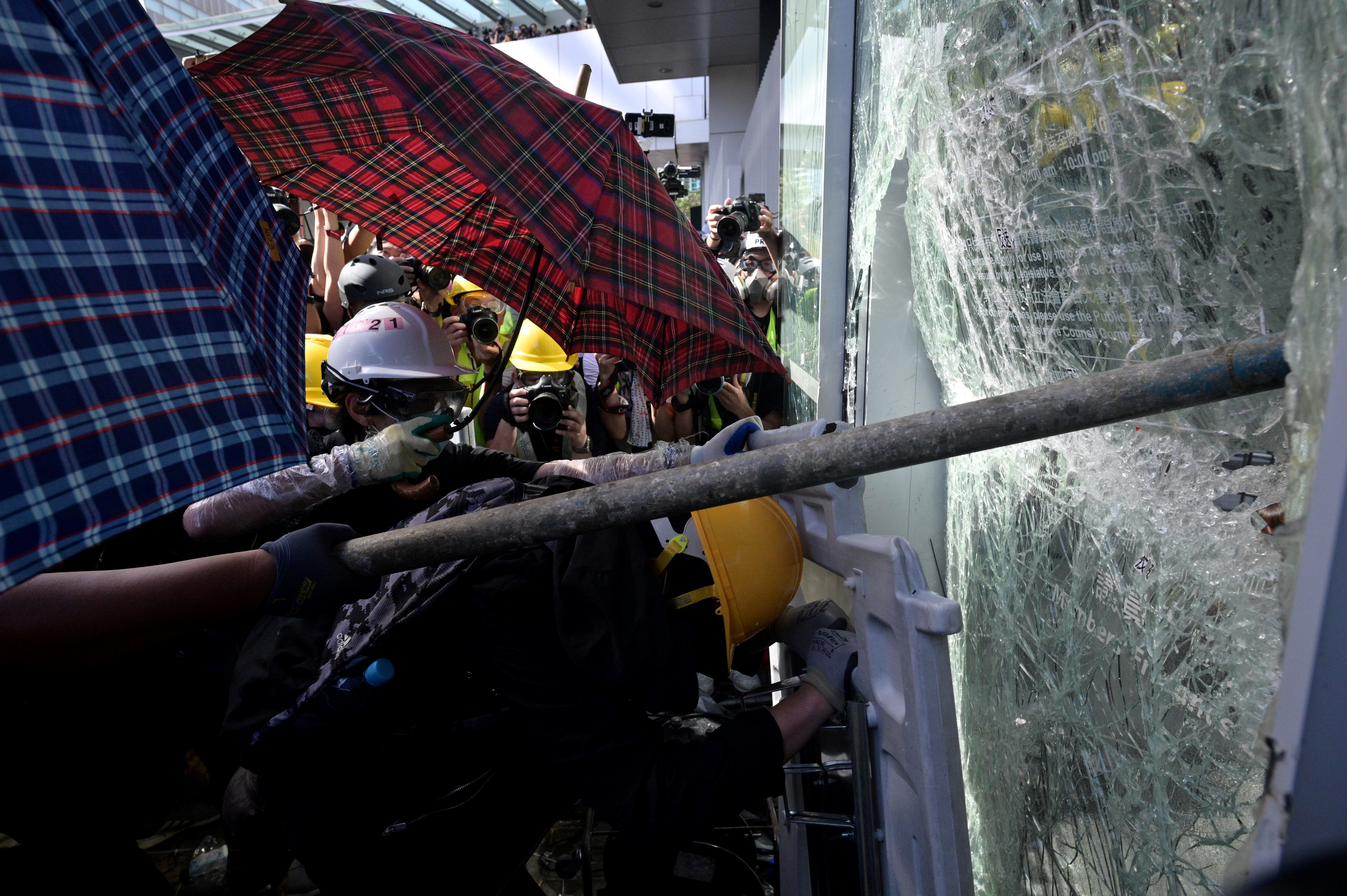Protesters attempt to break a window at the government headquarters in Hong Kong.