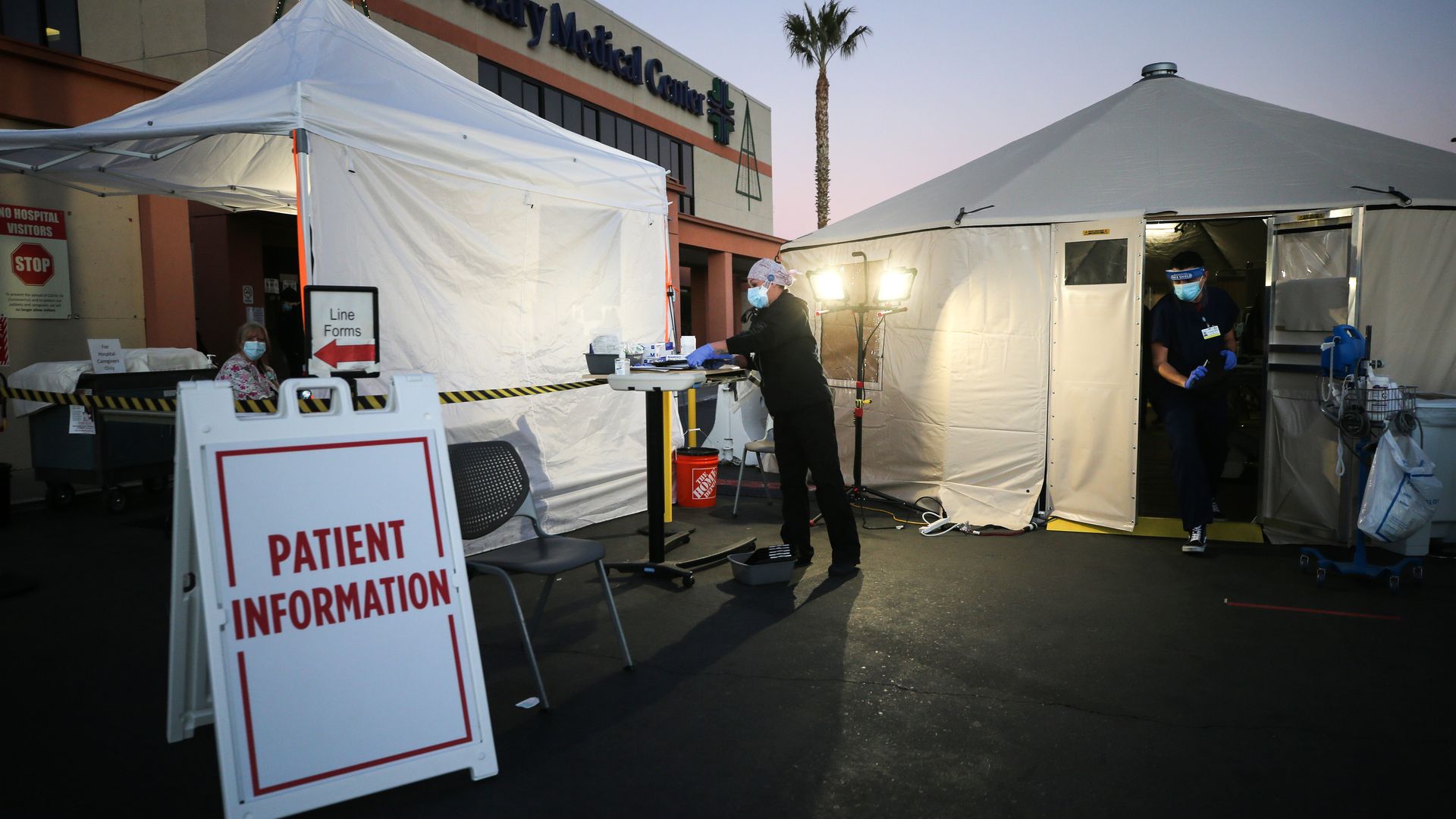 Health care providers work at triage tents outside Providence St. Mary Medical Center in Southern California.
