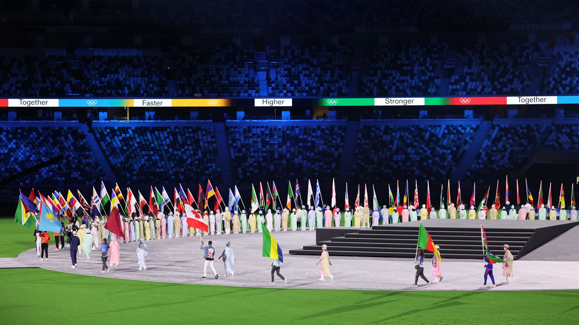 A parade of national flags begins the closing ceremony of the Tokyo Olympics on Sunday.