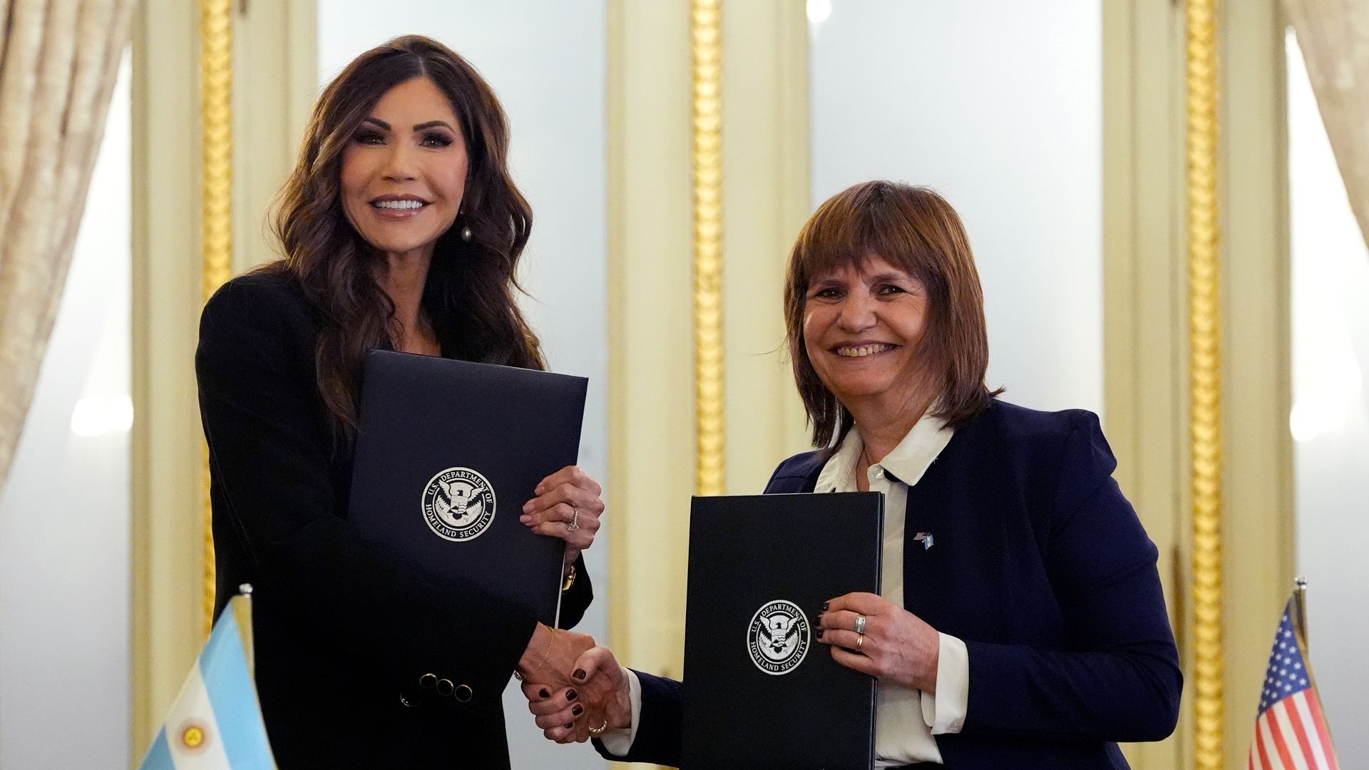 U.S. Homeland Security Secretary Kristi Noem shakes hands with Argentina Security Minister Patricia Bullrich.