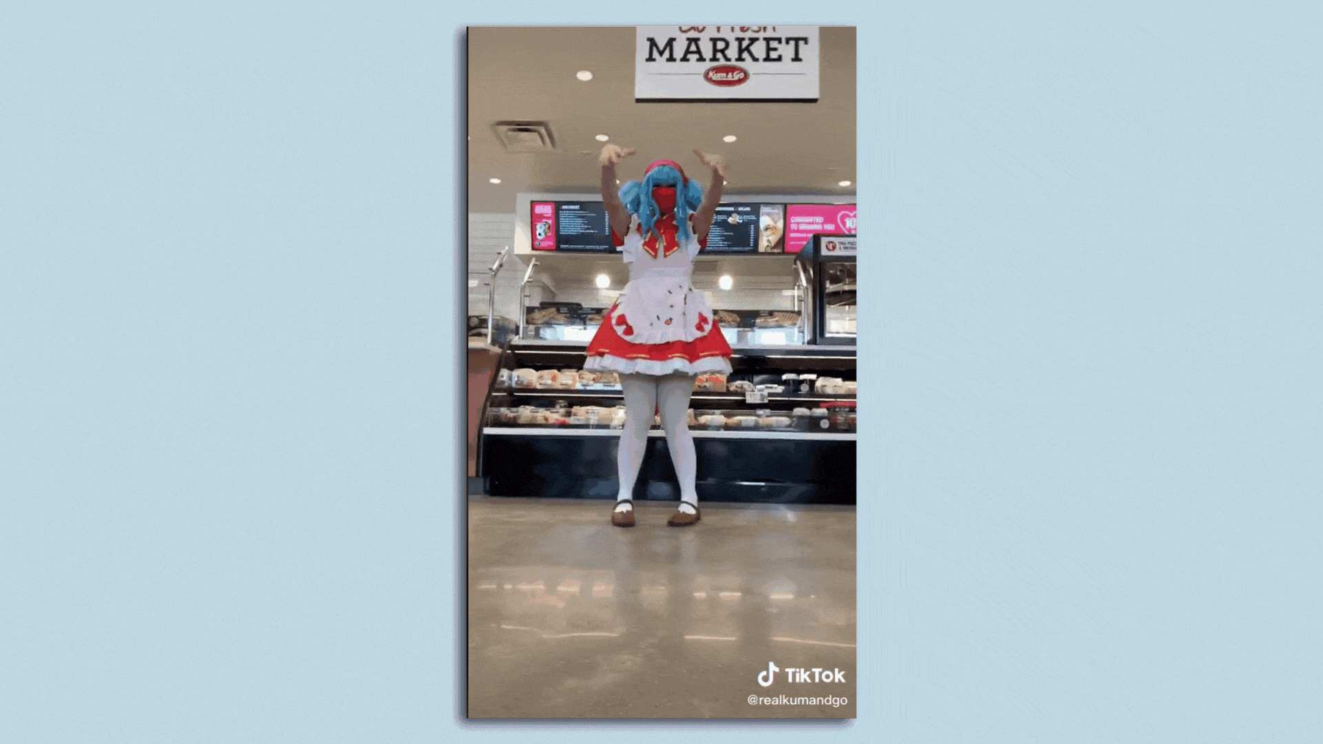 A gif showing a cosplay of Hatsune Miku at Kum & Go.