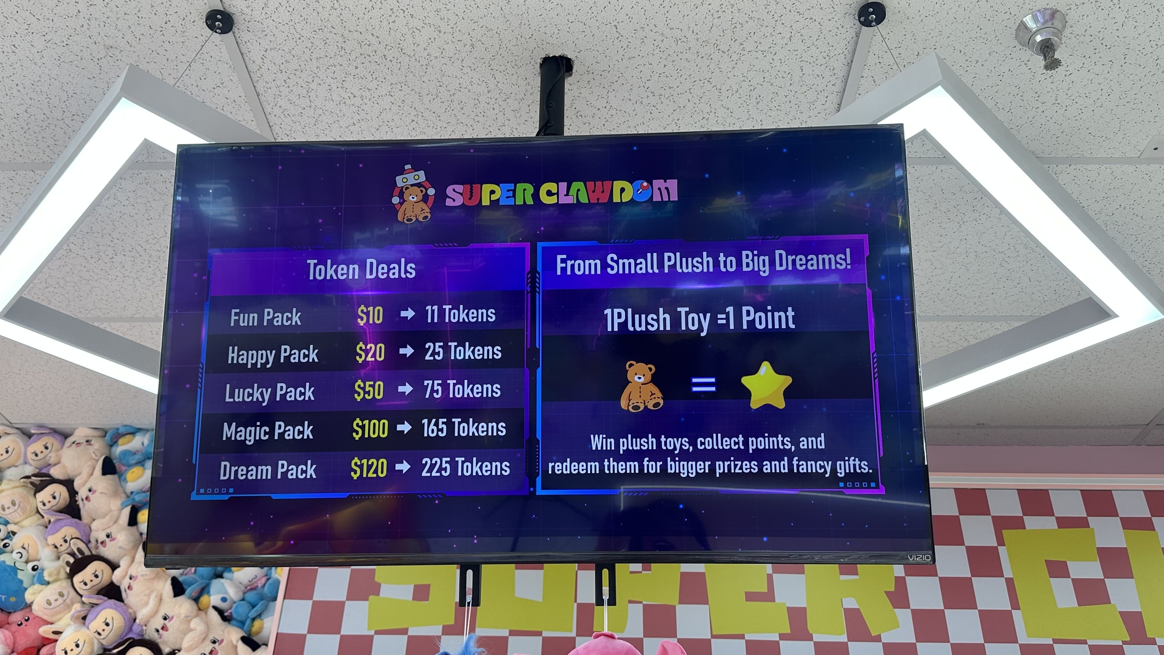 Screen from Super Clawdom showing token deals and plush toy points system: $10 for 11 tokens, up to $120 for 225 tokens. 1 plush toy equals 1 point to redeem prizes.