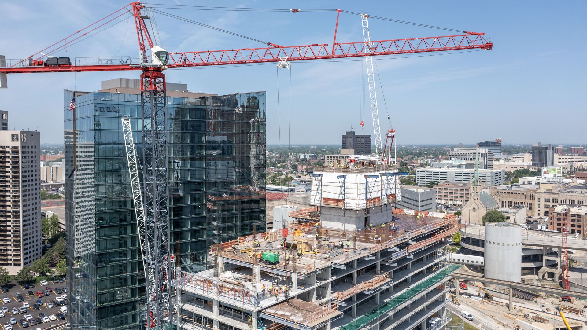 A construction crane in downtown detroit putting together a 25-story hotel that's not complete