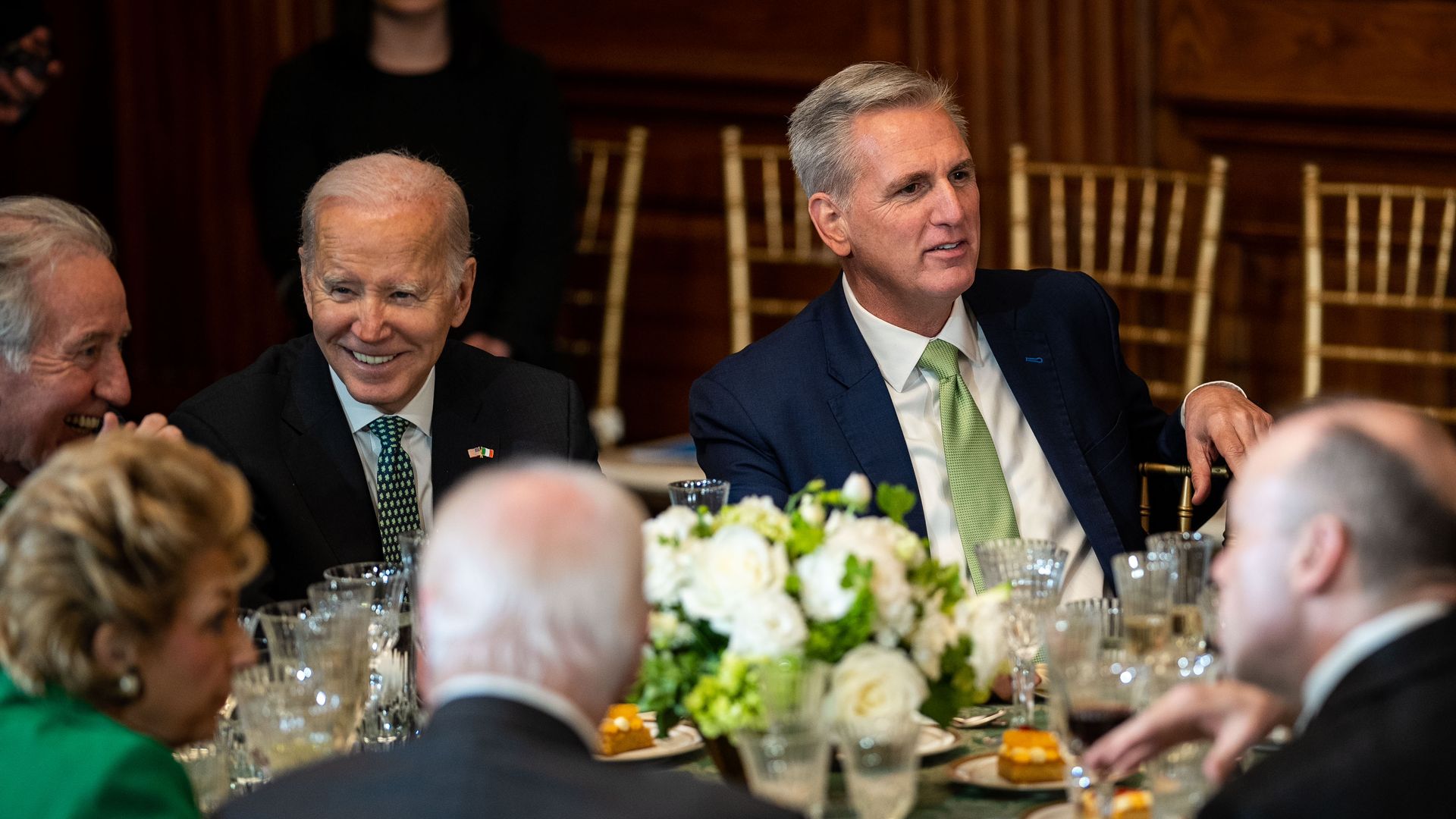 President Biden and House Speaker Kevin McCarthy, wearing green ties, sitting at a table.