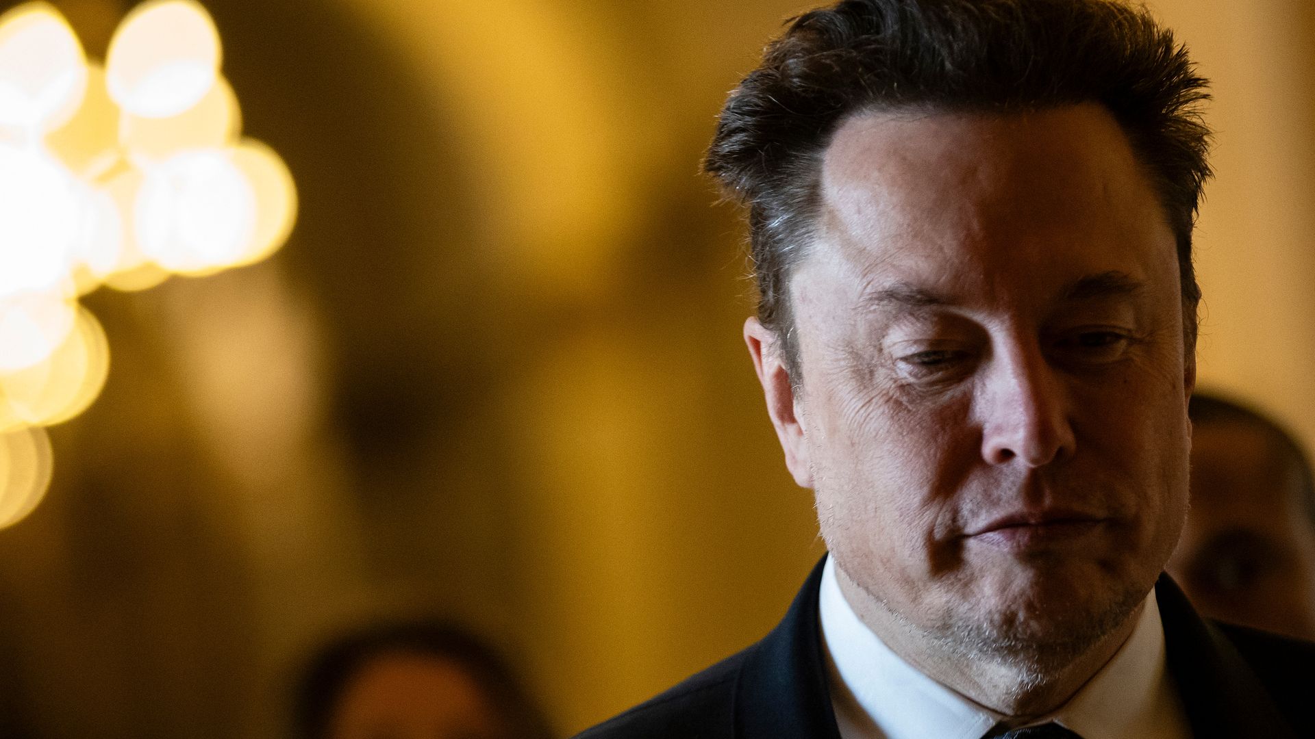 A man walking in a hallway. 