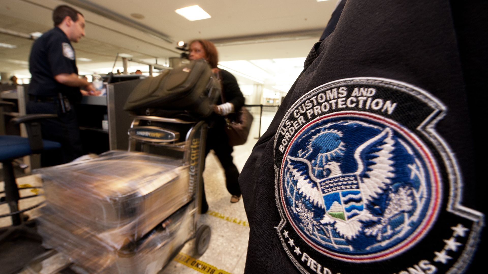 An international air traveler is cleared by a US Customs and Border Protection Offic inside the US Customs and Immigration area at Dulles International Airport (IAD