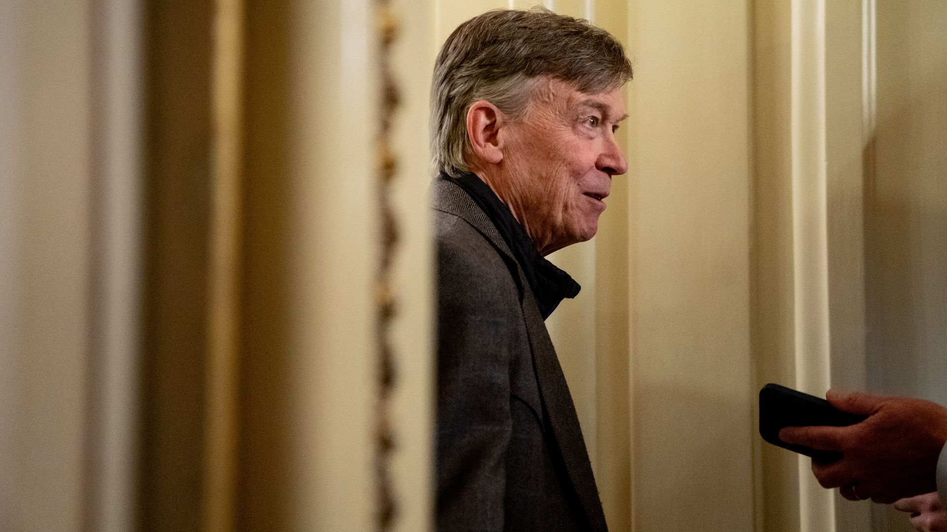 Sen. John Hickenlooper speaks to members of the media Nov. 9, 2025. Photo: Stefani Reynolds/Bloomberg via Getty Images
